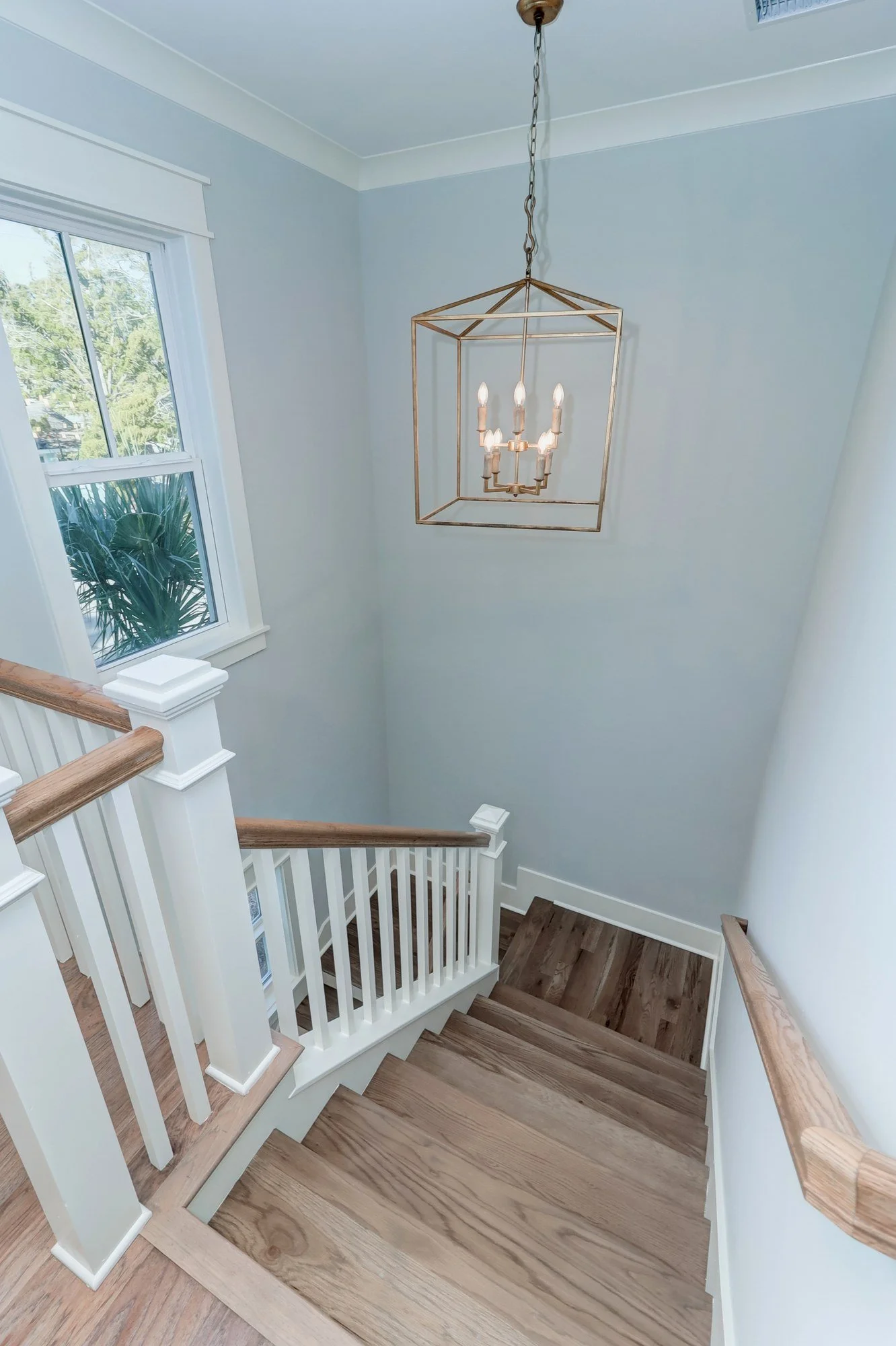 Upstairs landing with a brass lantern pendant in a Mount Pleasant SC custom home build