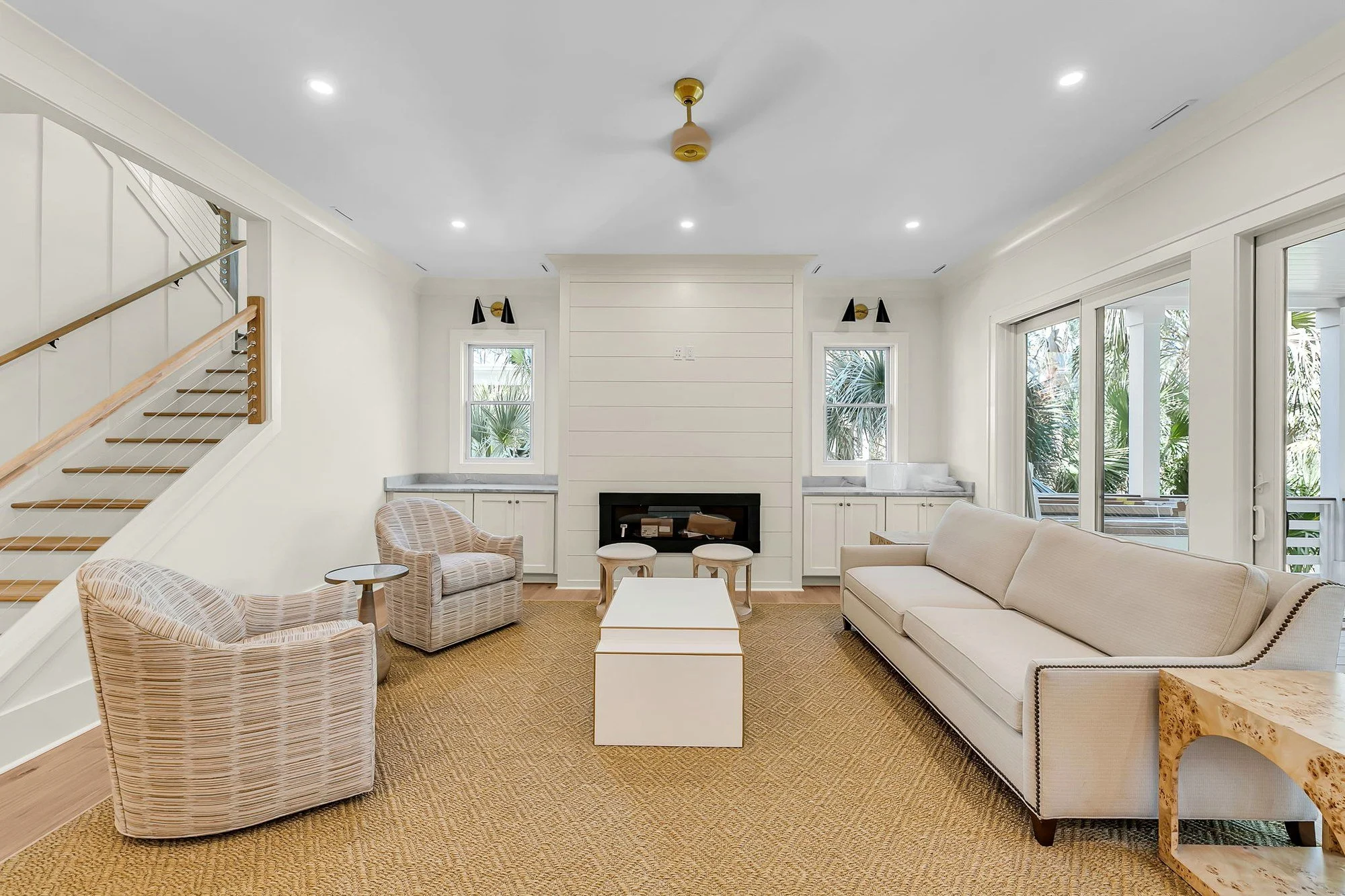 Living room featuring a shiplap fireplace surround in an Isle of Palms SC custom home