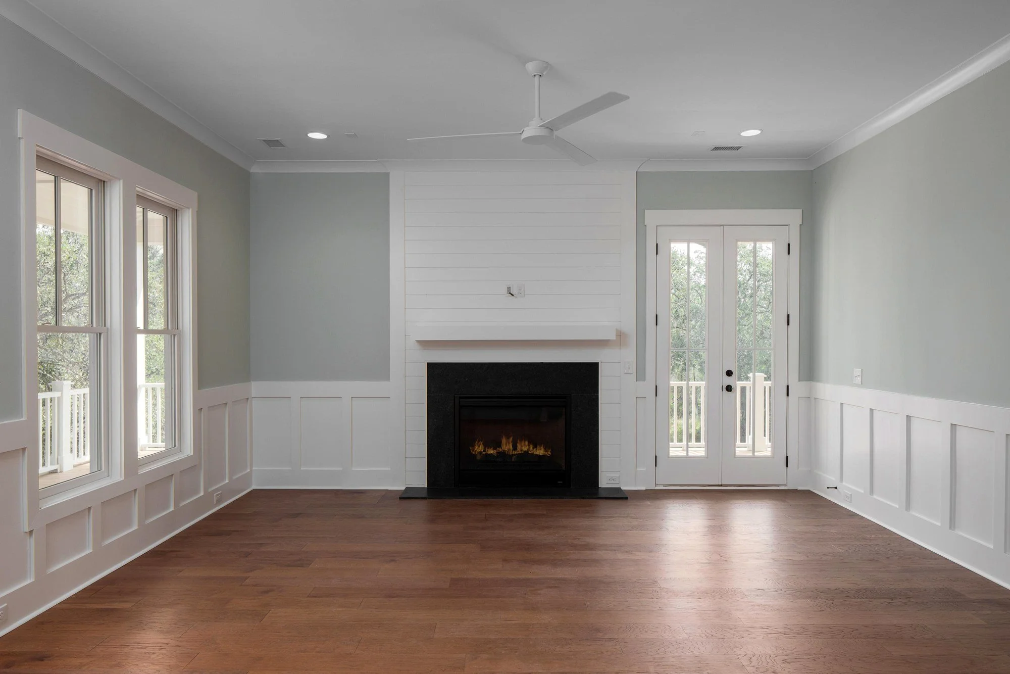 Living room fireplace and porch doors in a Charleston SC home by Iconic Developments