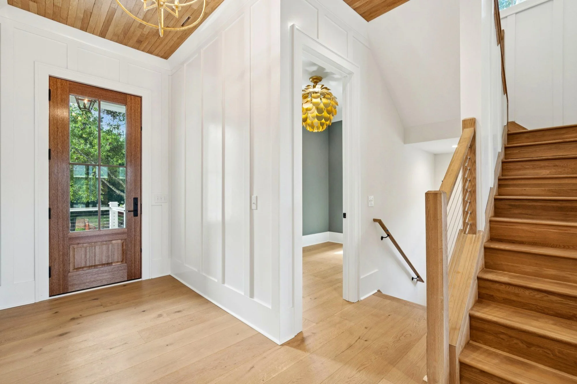 Entry hall staircase in a luxury custom home on Isle of Palms SC by Iconic Developments