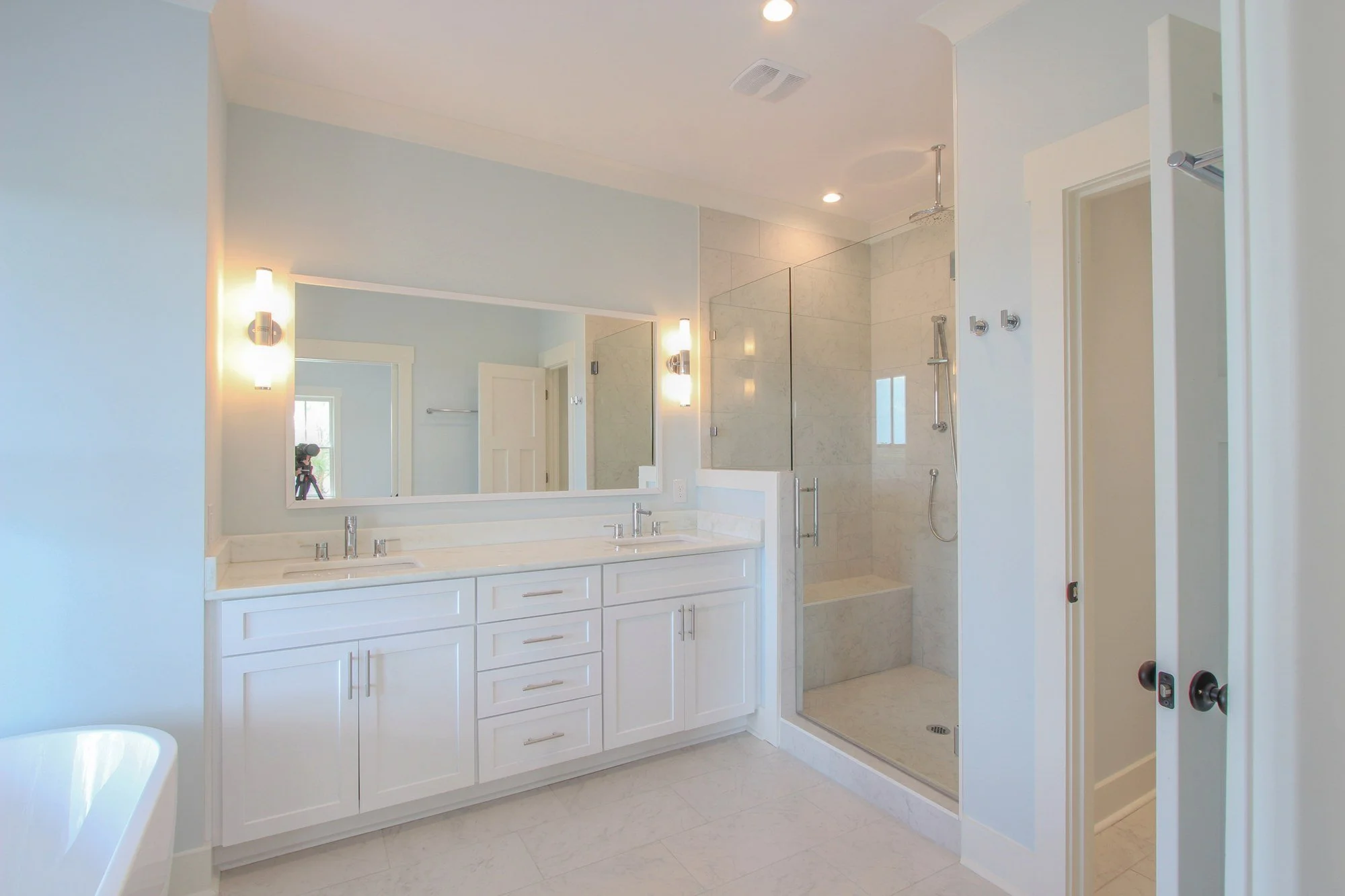 Primary bath vanity and tiled walk-in shower in a Johns Island SC custom home