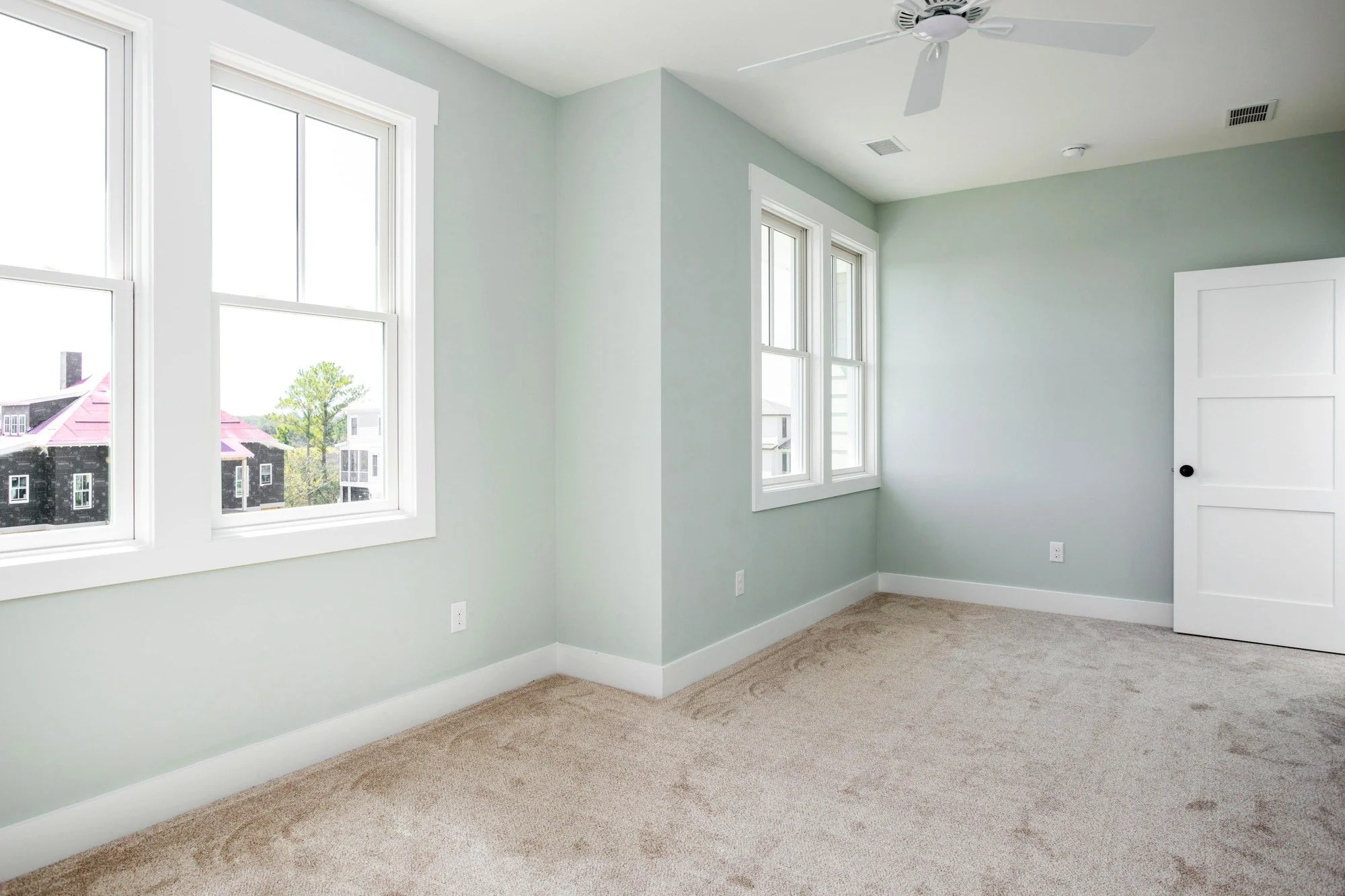 Guest bedroom with sage walls in a custom Charleston SC home by Iconic Developments