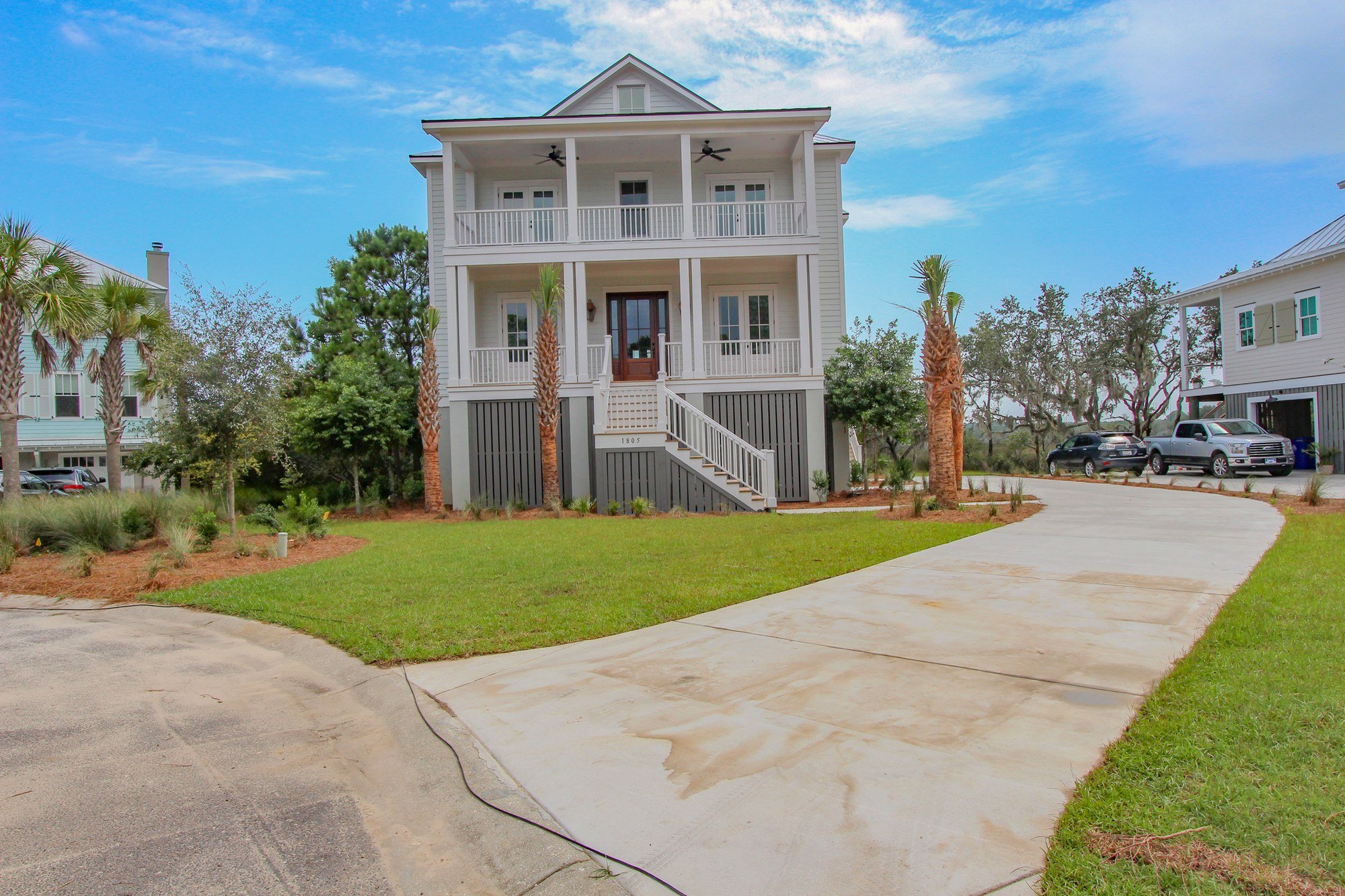 Custom Lowcountry home elevation featuring palmetto landscaping in Charleston SC
