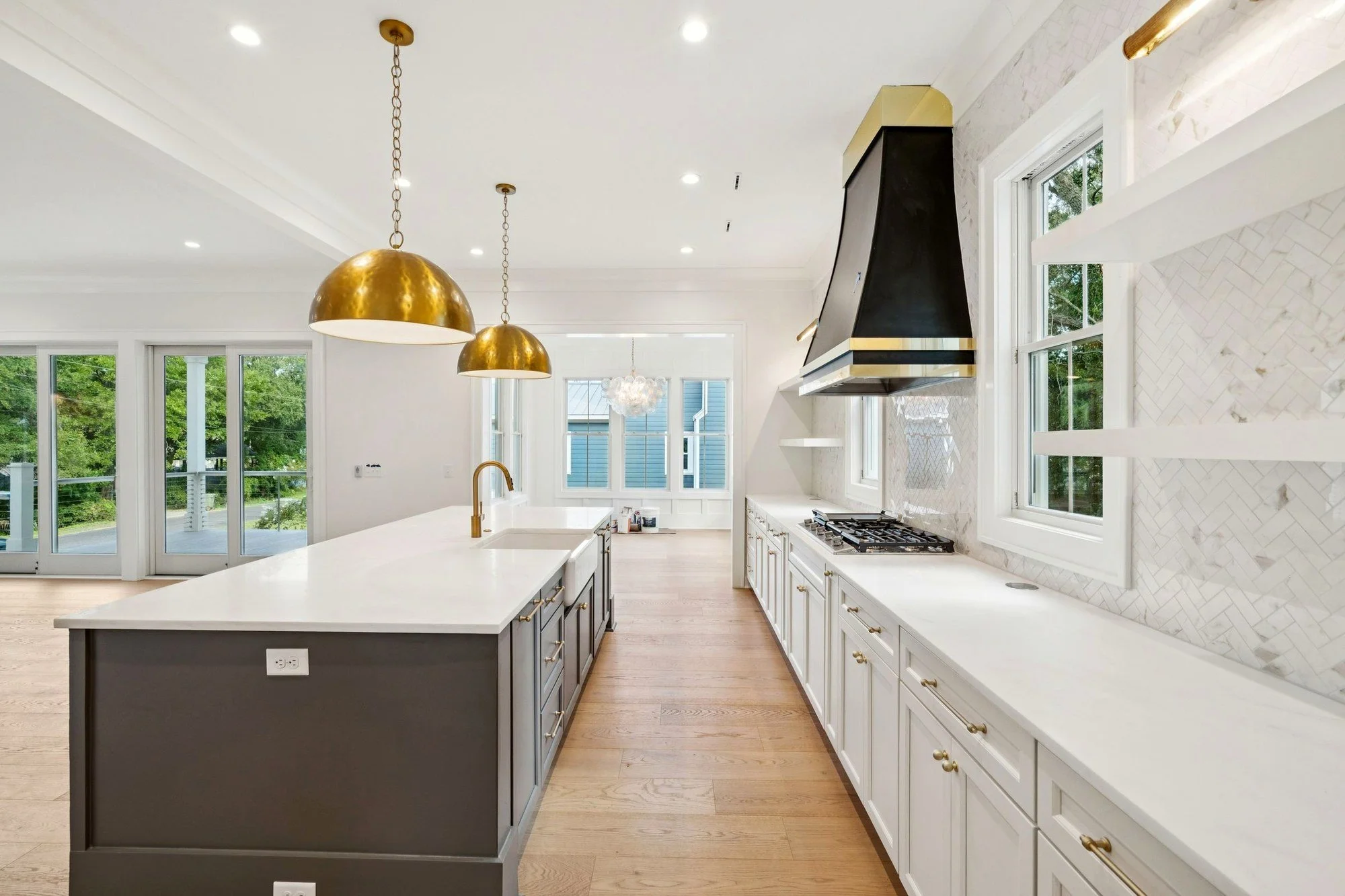Custom kitchen range hood and quartz island in a luxury Charleston SC custom home build