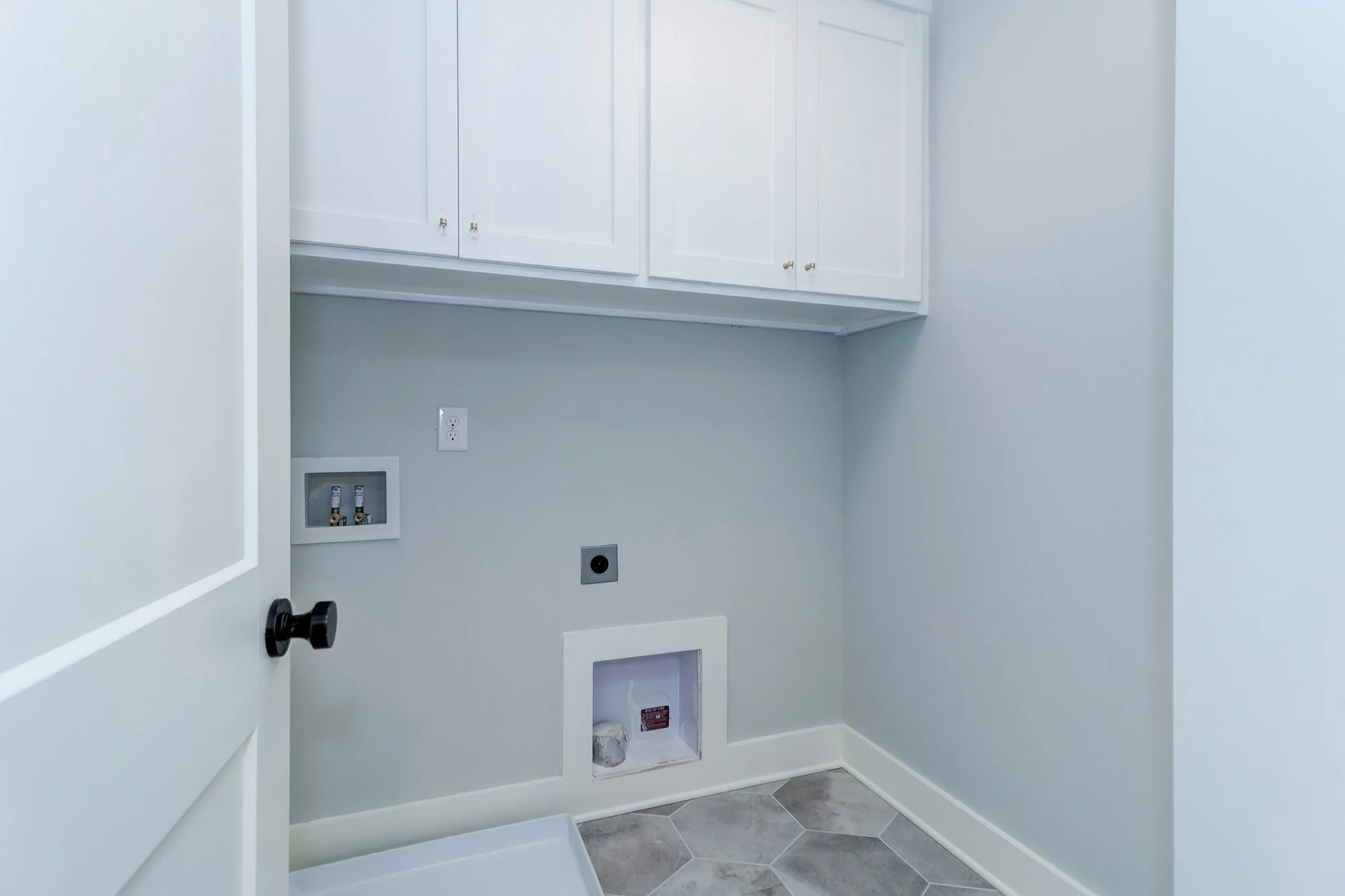 Laundry room with custom cabinetry in a Mount Pleasant SC home by Iconic Developments
