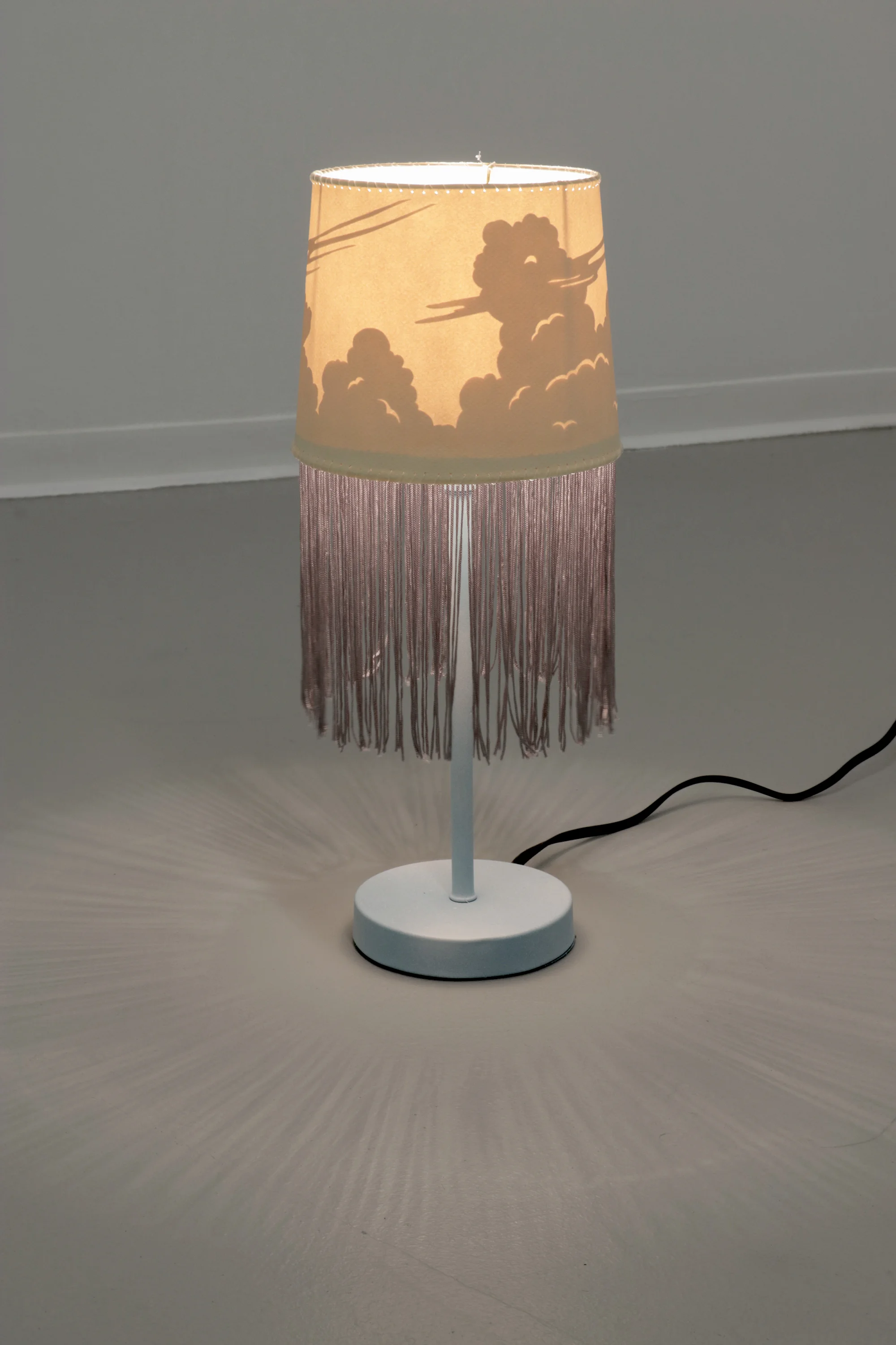 Untitled 2017 Motion-inactivated lamp, paper, fringe, fishing line, spraypaint