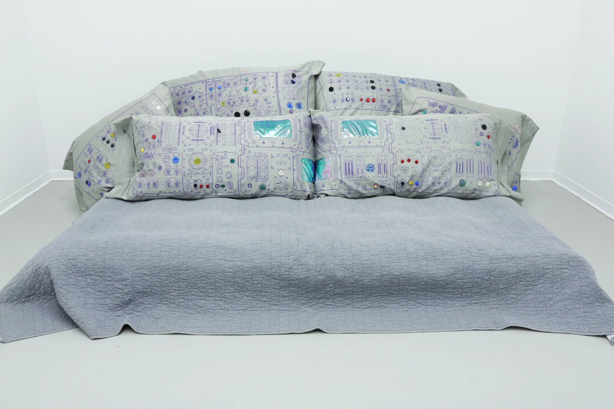 Not Here 2017 screenprint, buttons, and sewn fabric on pillow cases, air mattress, comforter