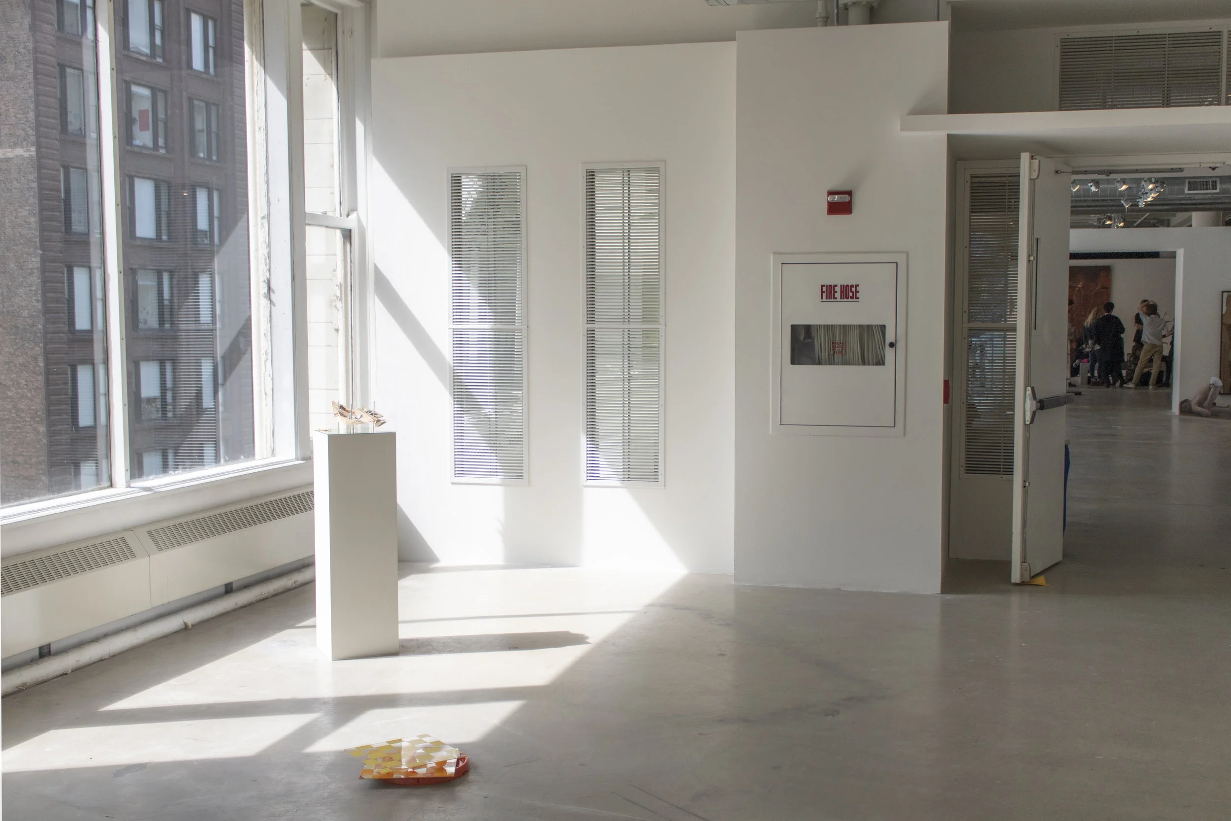 Untitled (installation view, left of the fire hose) 2019 Stud pine, drywall, primer, latex paint, plywood, mirrors, steel grilles 118” x 89”