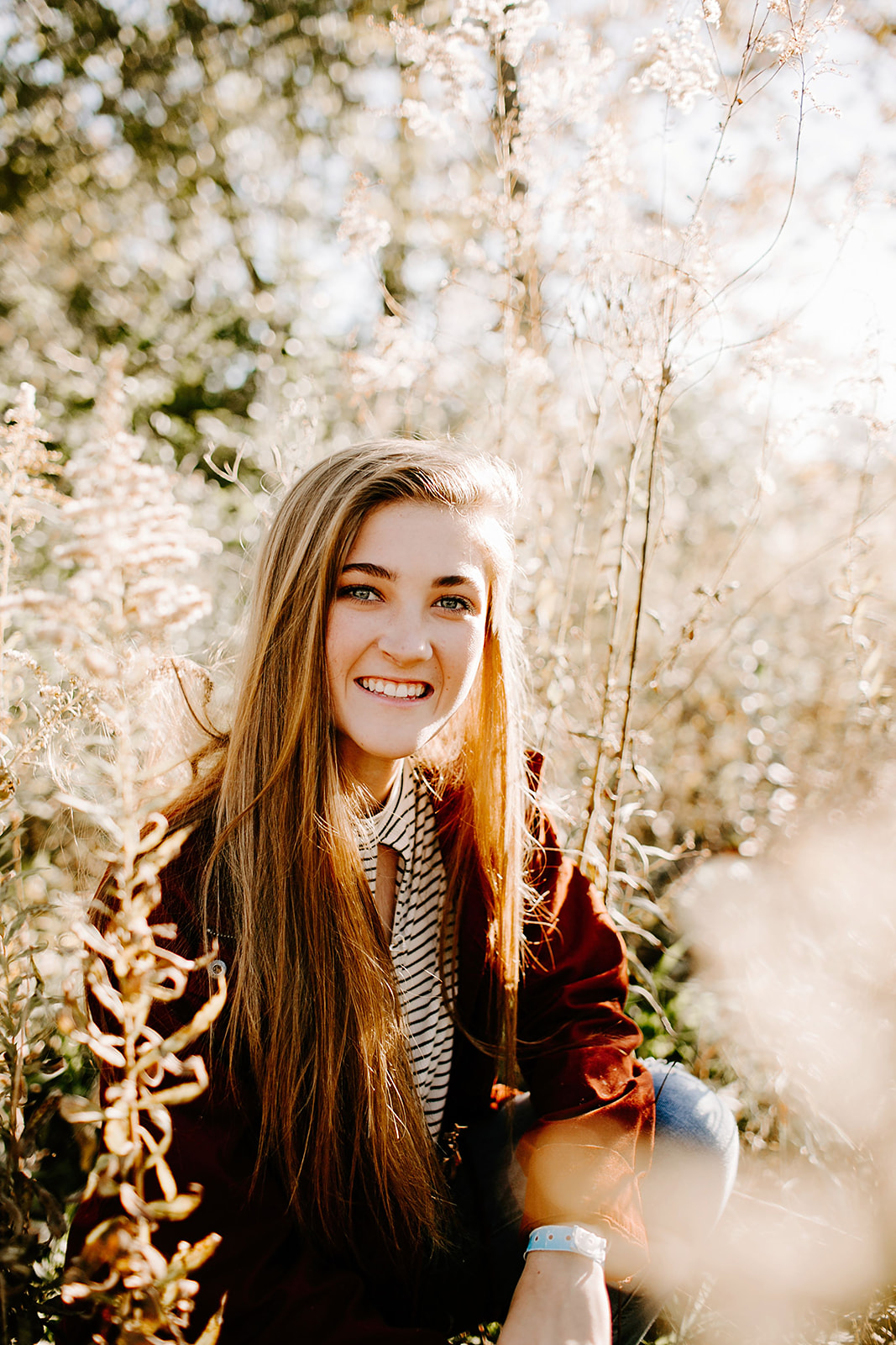 a senior photo at their senior session in the field at Carmel, Indiana