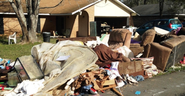 "Gutting": wet flooring and furniture must be removed to allow the house to begin to dry.