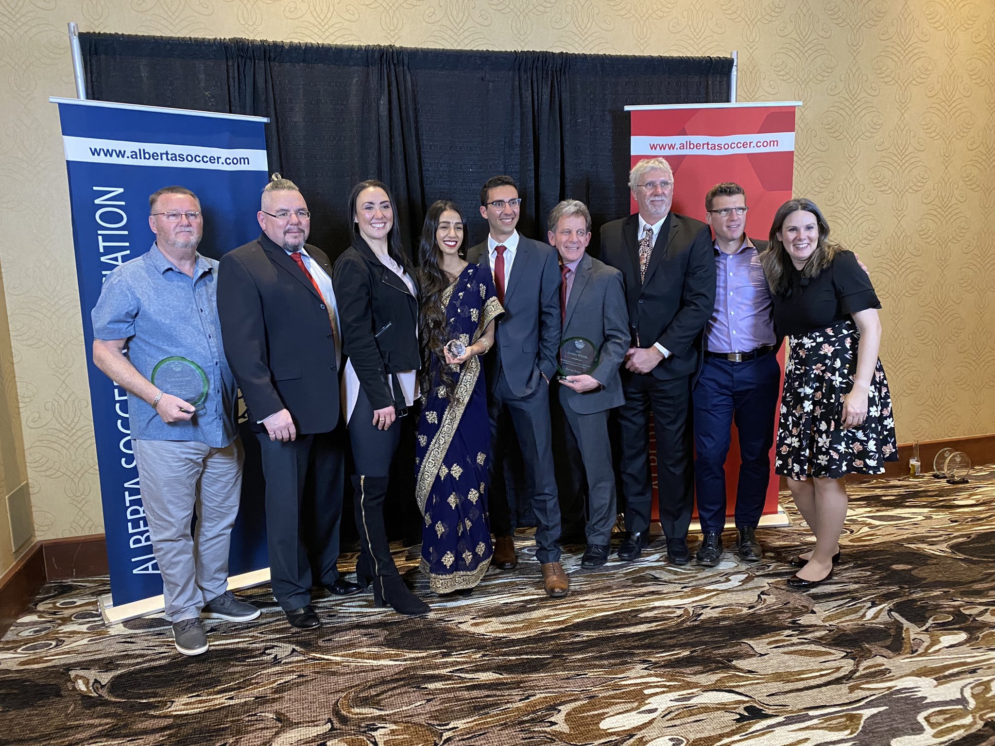 L-R: Rob Urquhart, Richard Sansregret, Michelle M. Holmes, Harsimrit Lakhyan, Mazzen Black, Kevin Jones, Laurie Hastings, Dave Gantar, Sheena Dickson