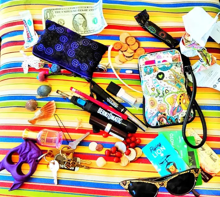 Coin purse Dollar Two tubes of lipstick pink and red Business cards sunglasses Lipliner Mascara Butane torche Perfume Ring Tampon Dirty old Pill Bone Seashells Tiny bow Hair pin Boston baked beans Change Wallet Coin purse Keys Candy wrappers Reciepts