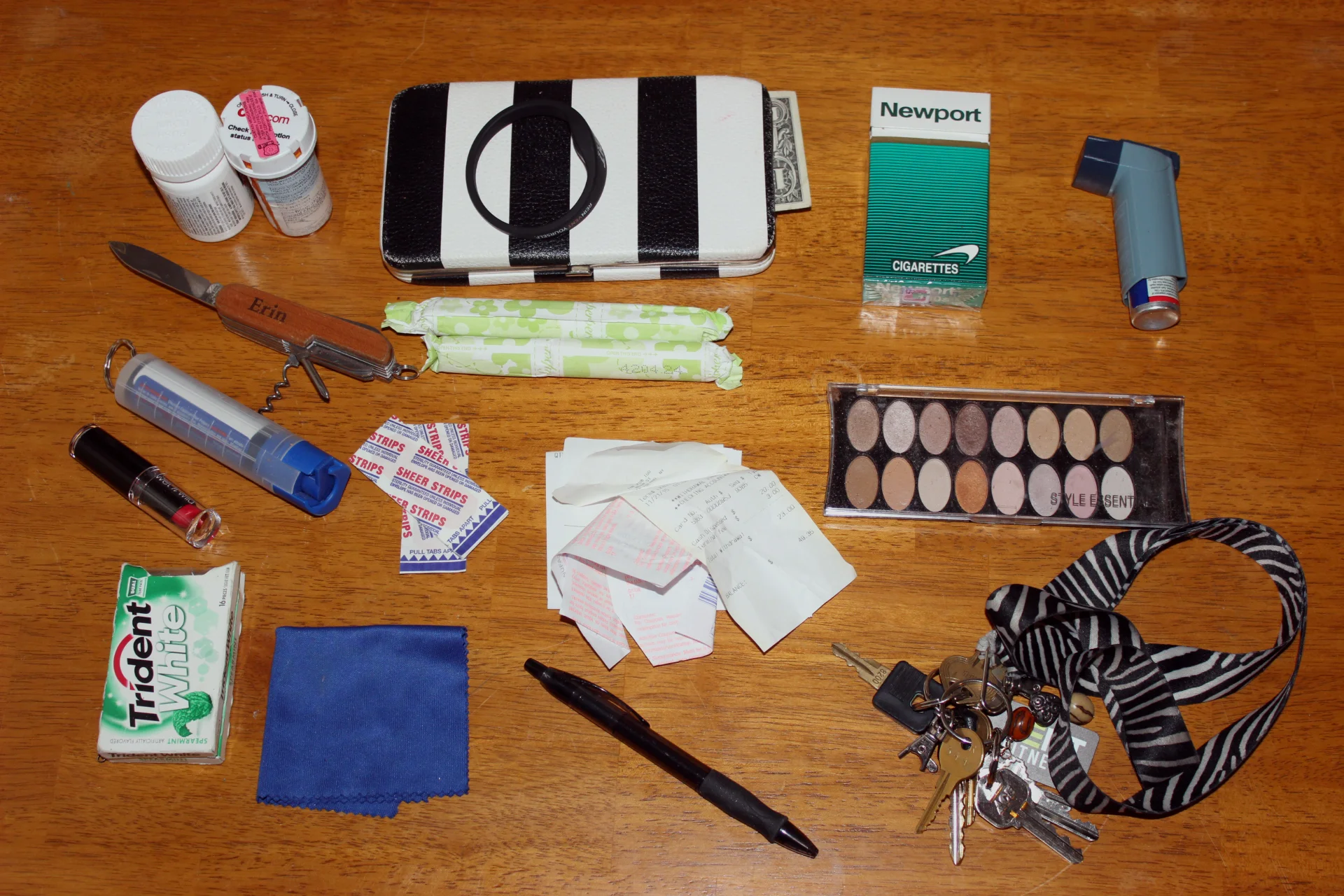  Migraine medication Multi-tool Pepper spray  Lip stick Gum Microfiber glass cloth Band aides Tampons Wallet Gym access wrist band Receipts  Coupon Pen Keys Eye shadow Newports Inhaler 