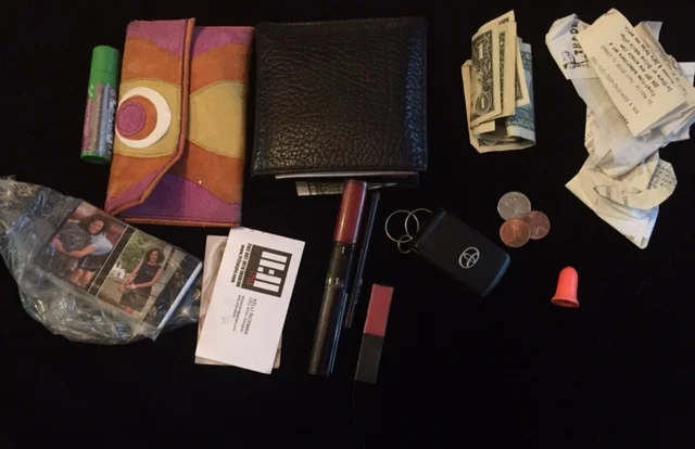 Lip balm change purse wallet $ receipts business card (self and others) lipsticks eyeliner pencil key change earplug