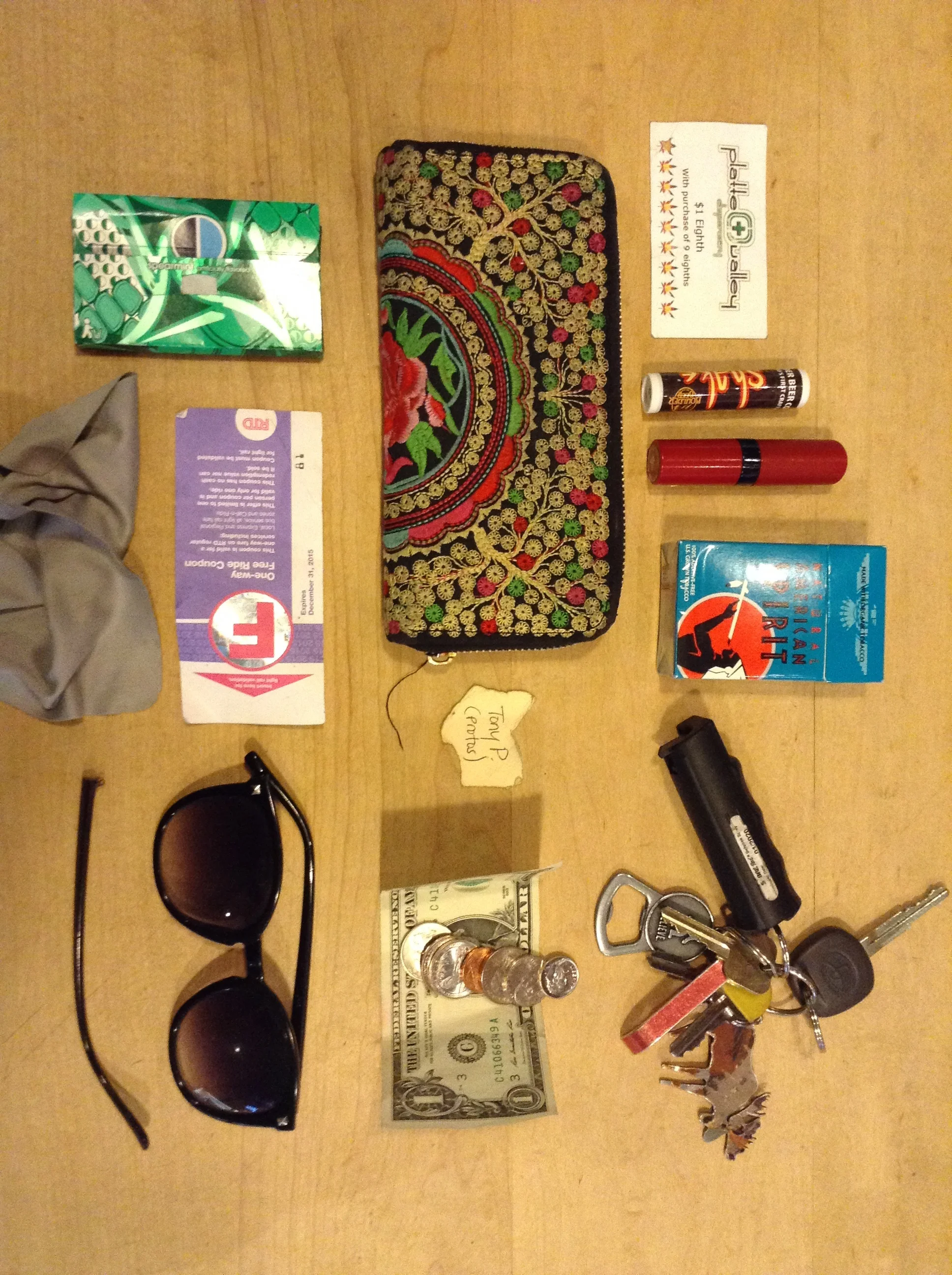   Keys with pepper spray   Bus fare   Broken sunglasses   Cigarettes   Wallet   Gum   Free bus ride ticket   Dispensary punch card   Red lipstick   Chocolate porter flavored chap stick   Secret Santa scrap   Eyeglasses wiper    