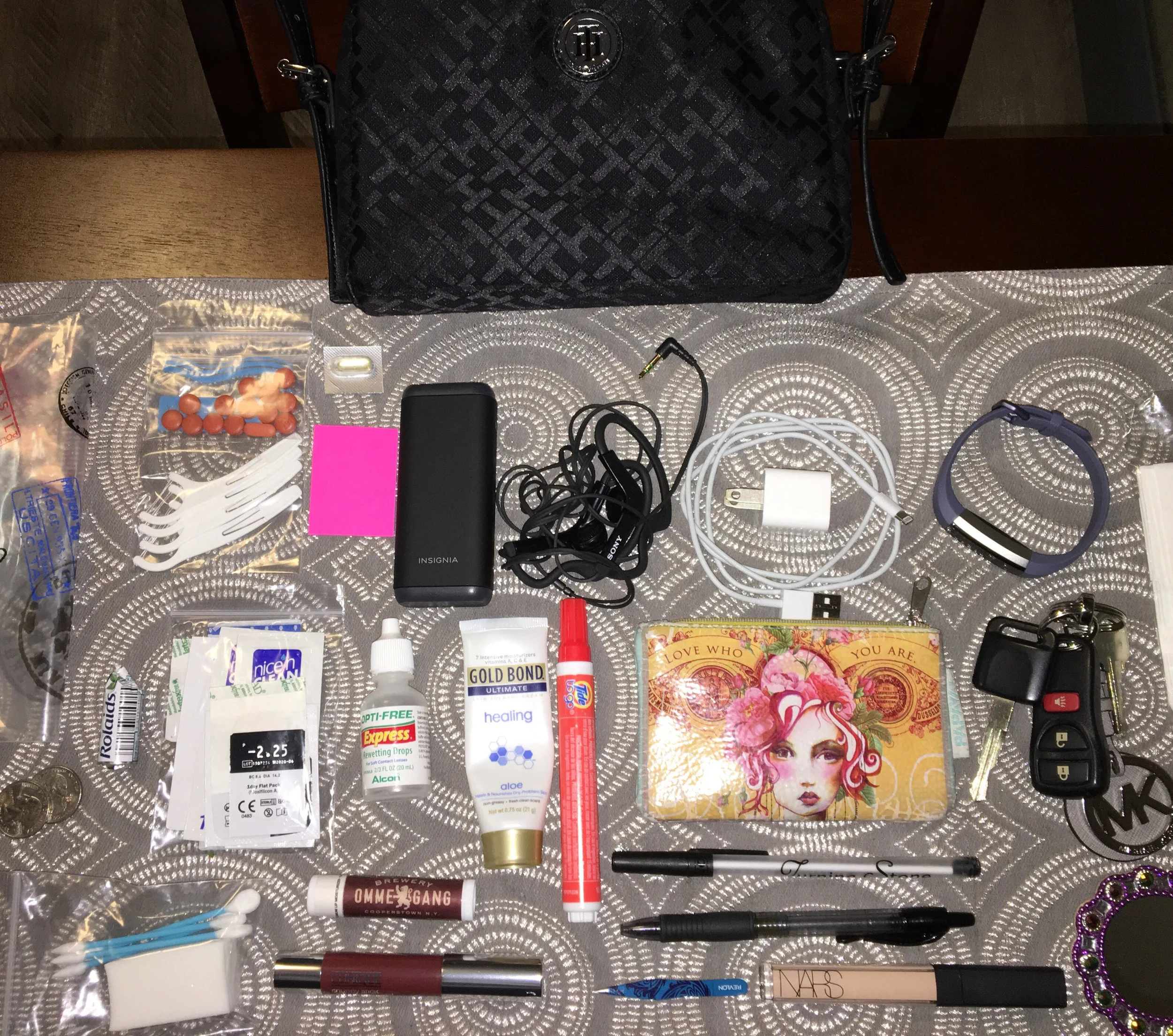  - Ziplock bag to hold small items  - Ibuprofen - Benadryl capsule - floss picks - Rolaids - contact lenses - bandaids - eyeglass wipes - makeup sponge and pointed Q-tips  - contact lens drops - Tide stain stick - NARS concealer - Clinique lipstick -