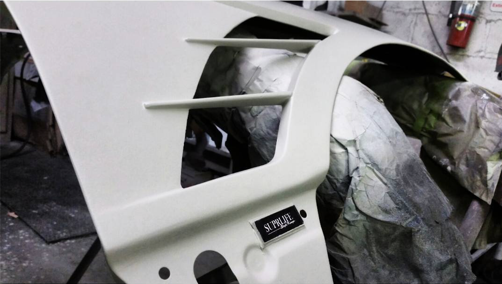 -the piece is ready for paint. Exposed now is the "SUPRLIFE Style Kings" glass badge. This badging will be hidden.