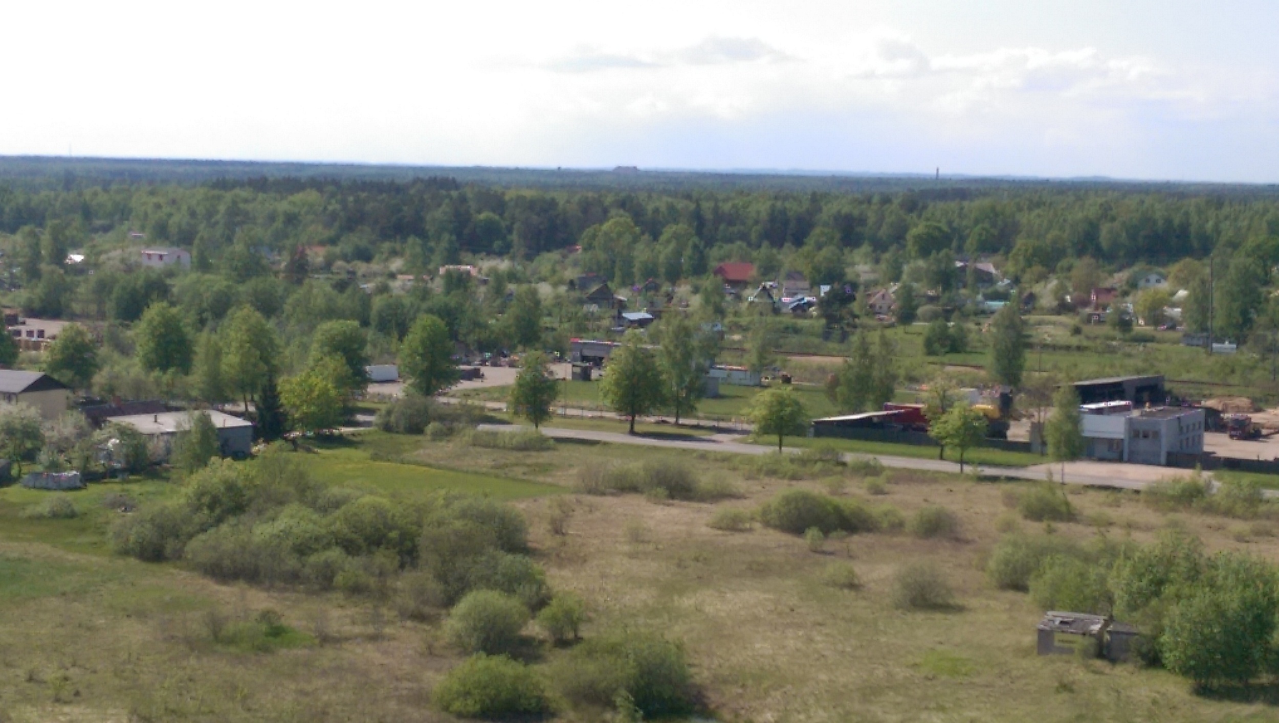 Further round nearby fields, houses, industrial and small holding units.