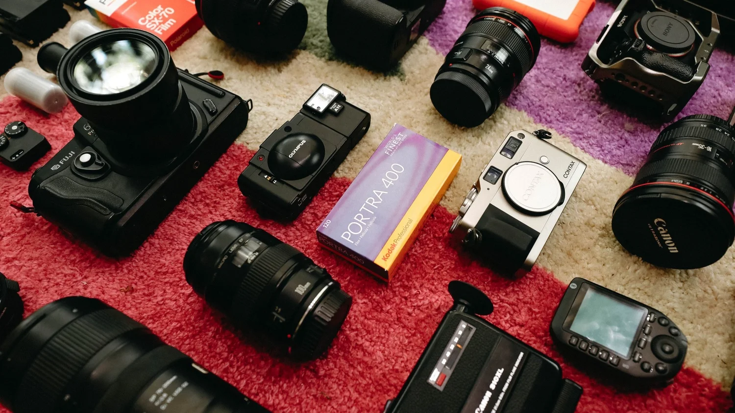 Camera bodies, lenses, and film laid out for rent