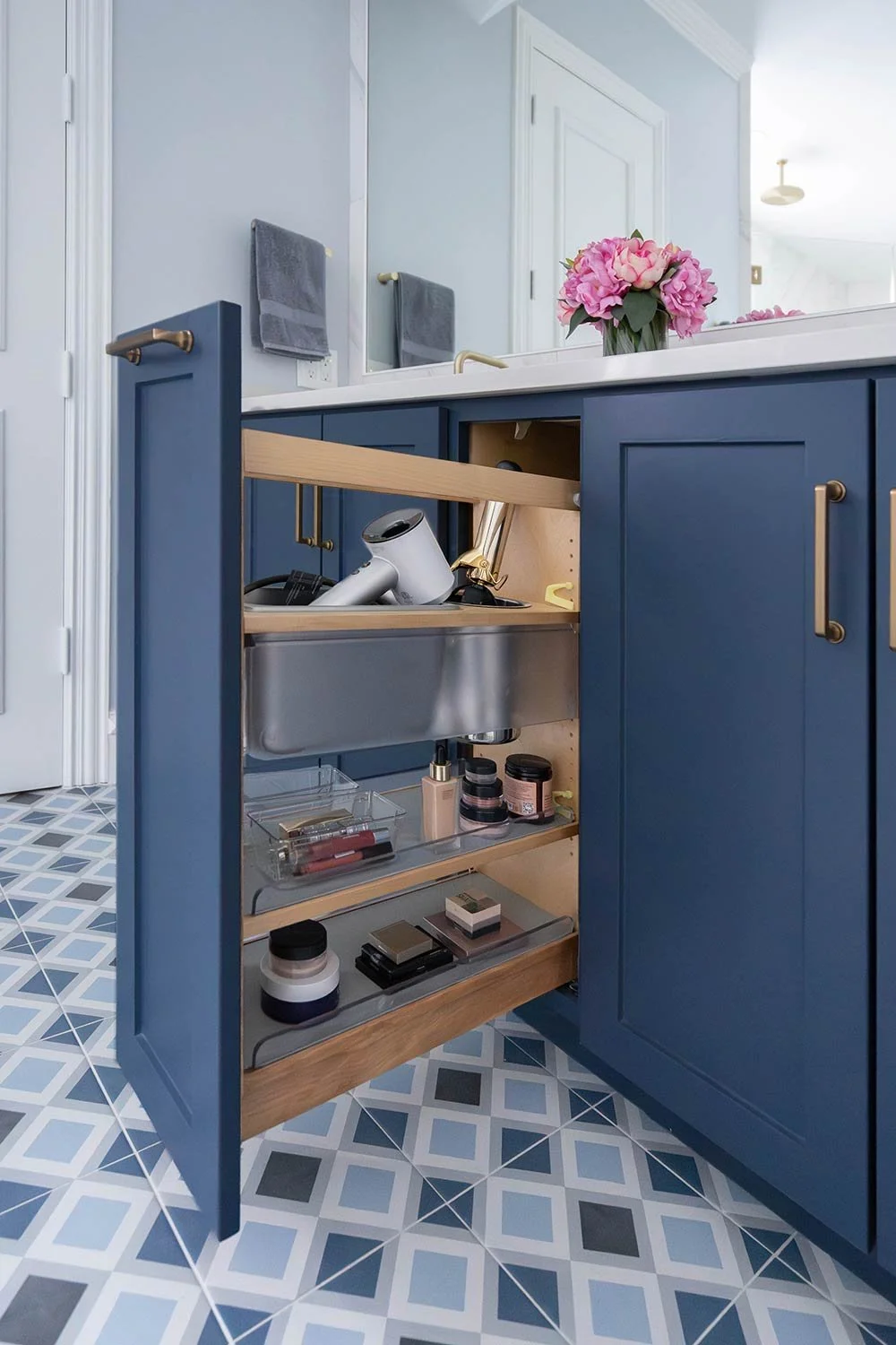 Pull out blue cabinet drawers with holder for hair dryer