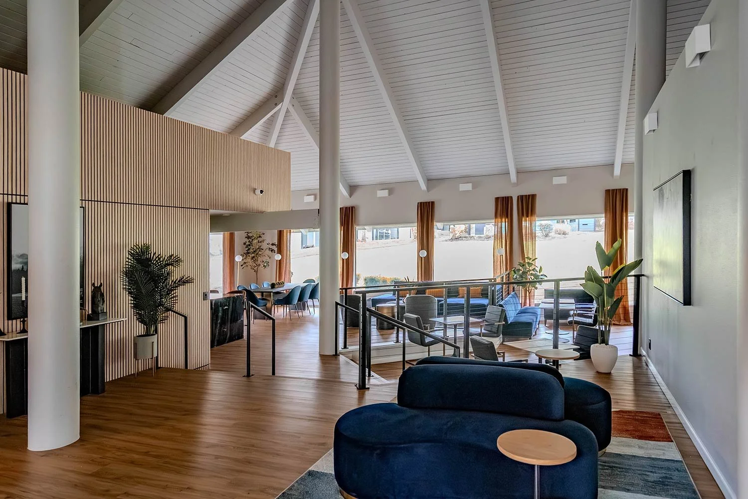 Bright blue couch and orange curtains in clubhouse