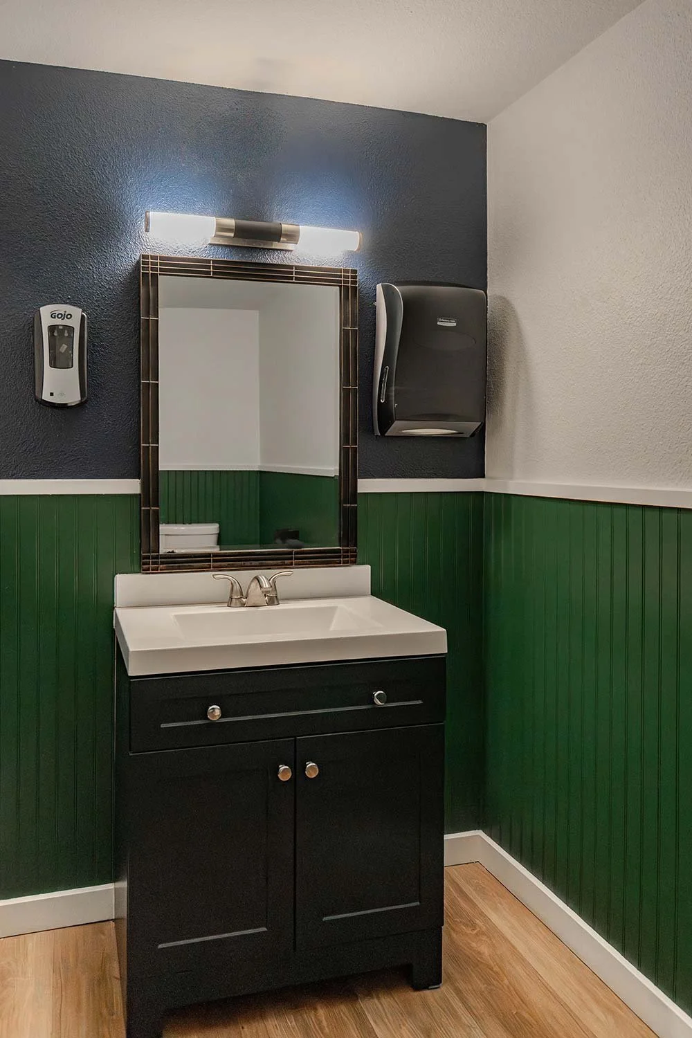 Green and black bathroom in apartment building