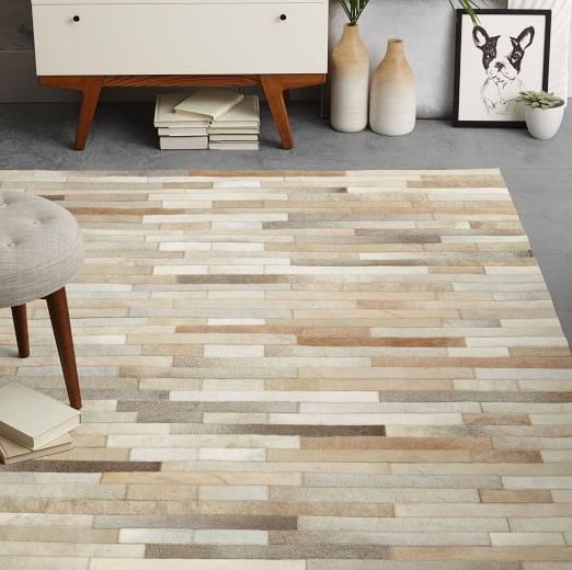 Linear designed patched hide rug. Very structured look.
