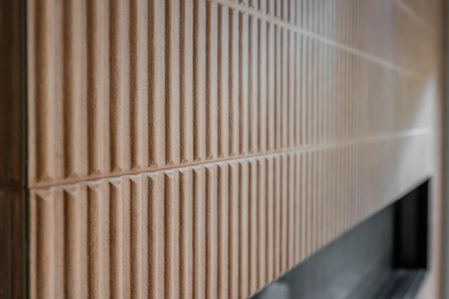 Custom tile that goes from floor to ceiling and surrounds electric fireplace