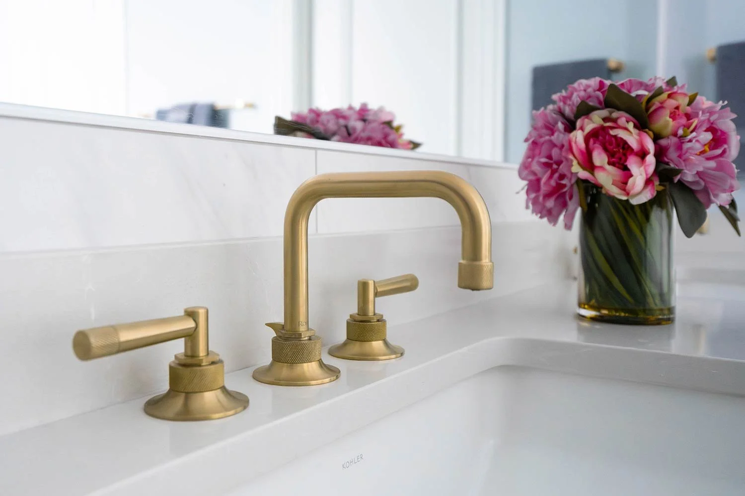 Brushed gold faucet in primary bathroom