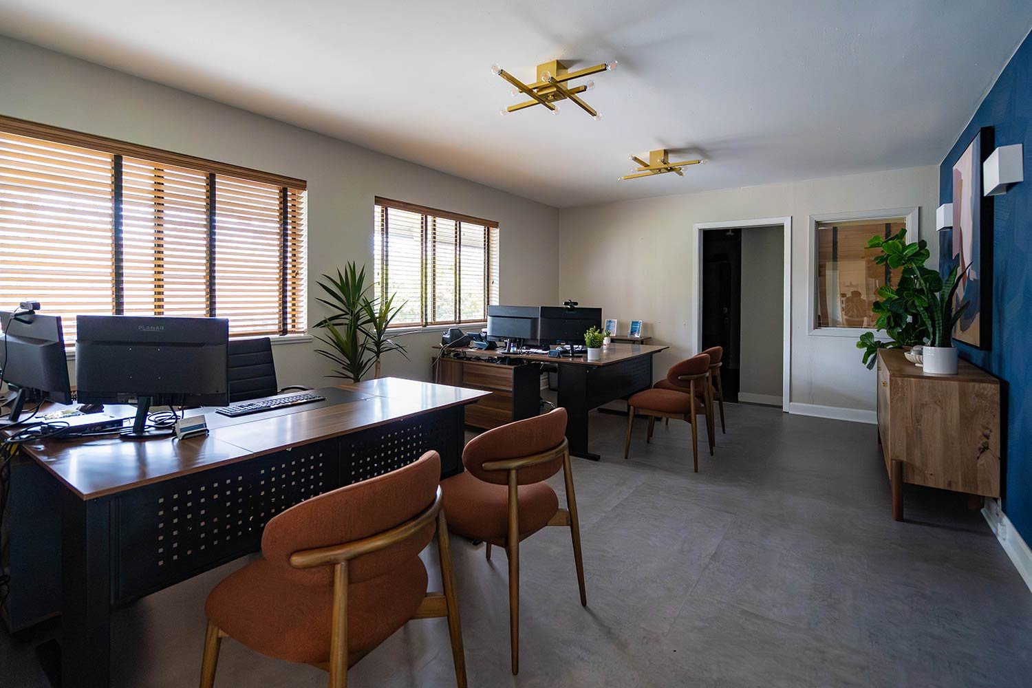 Leasing office with unique blue wall and complimenting chairs