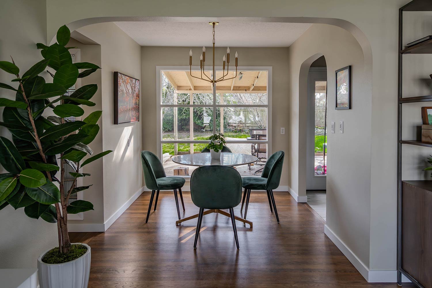 gold chandelier in dinning nook with light filled windows