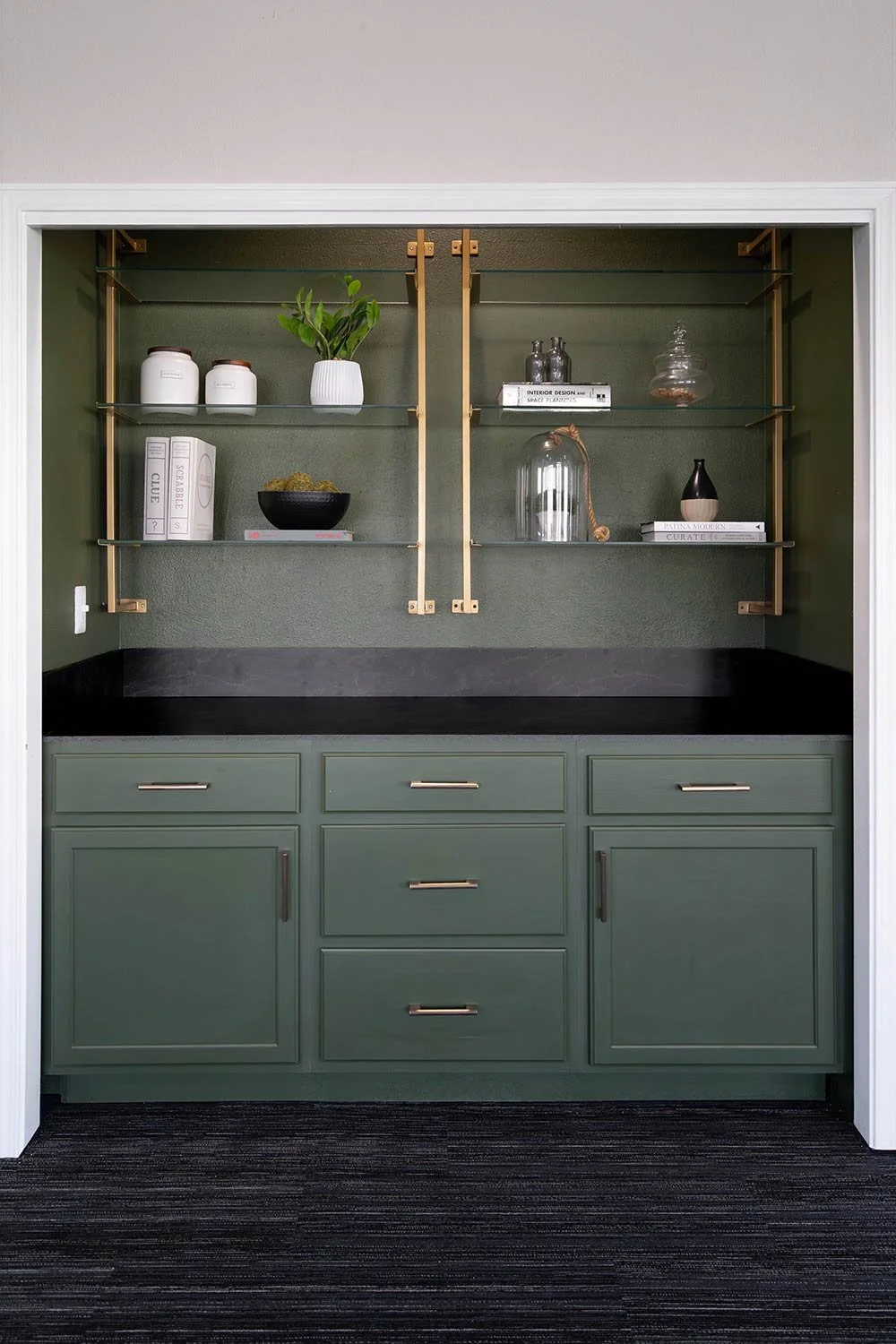 Dark green cabinets in wet bar design. color drenching