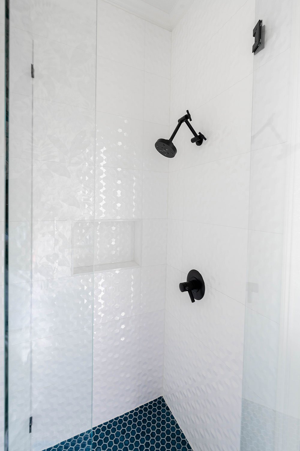 walk in shower, black matte hardware for shower. hand held wand.