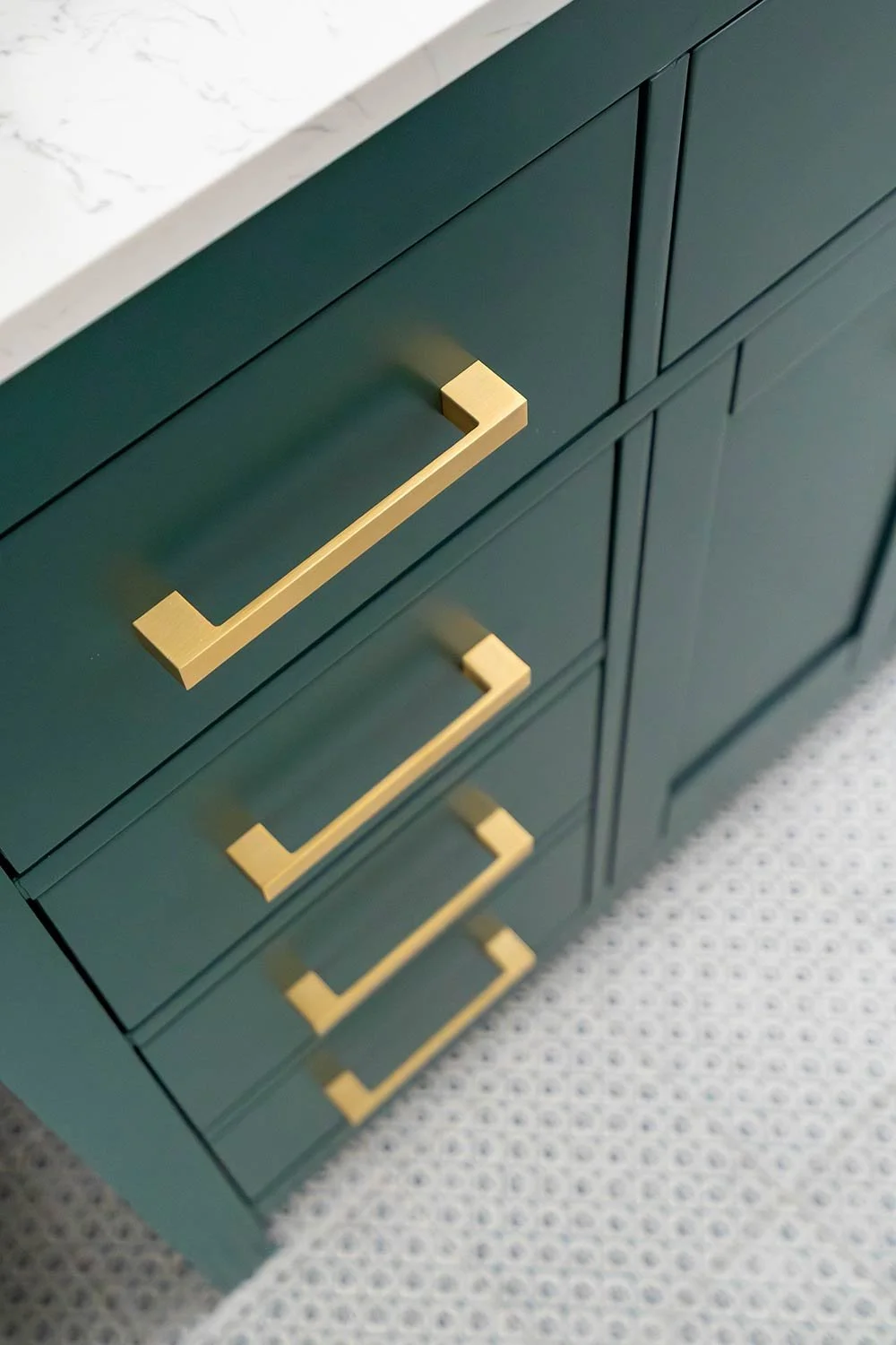 gold hardware on vanity drawers with color drenched vanity