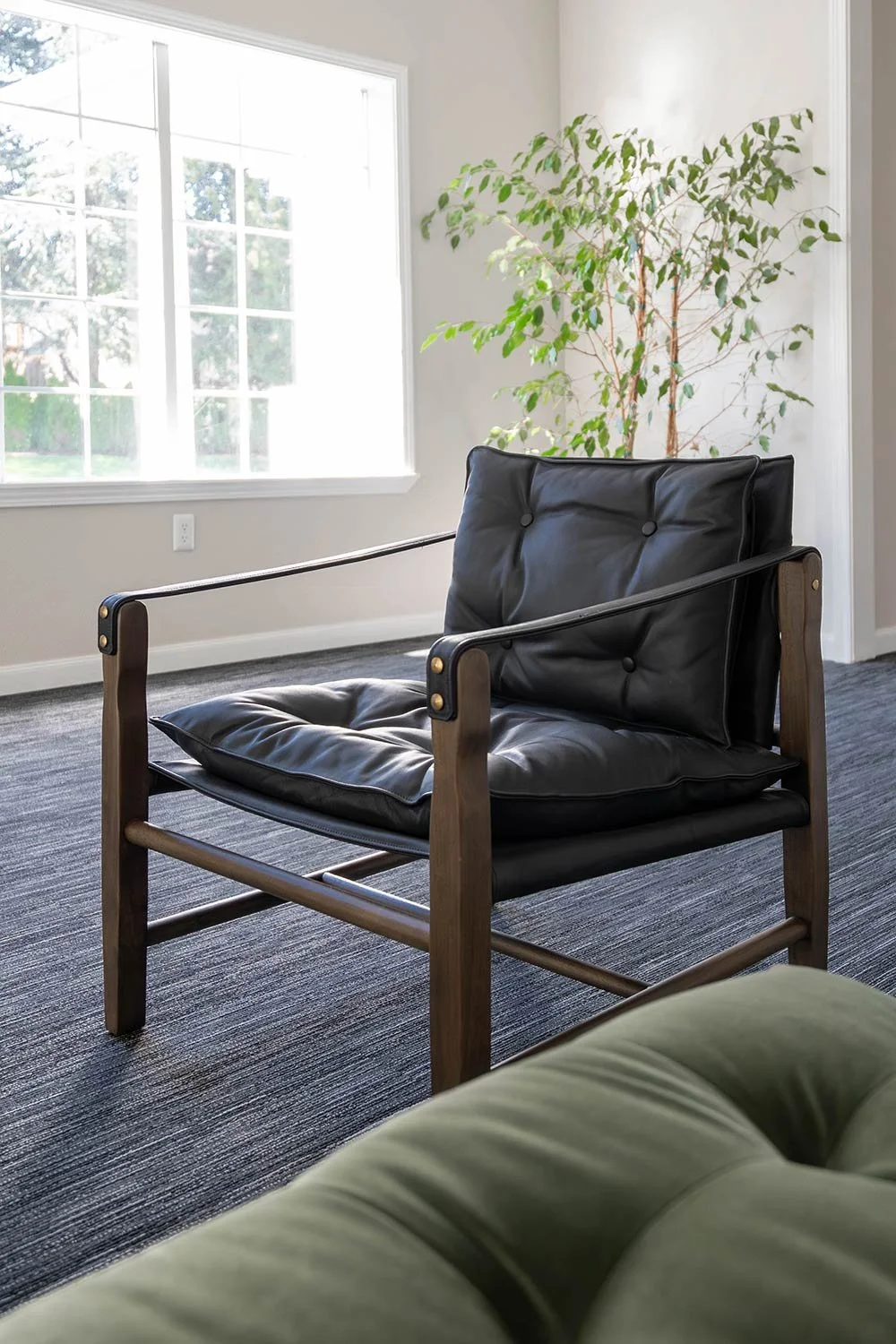 Black leather chair with dark wood tones