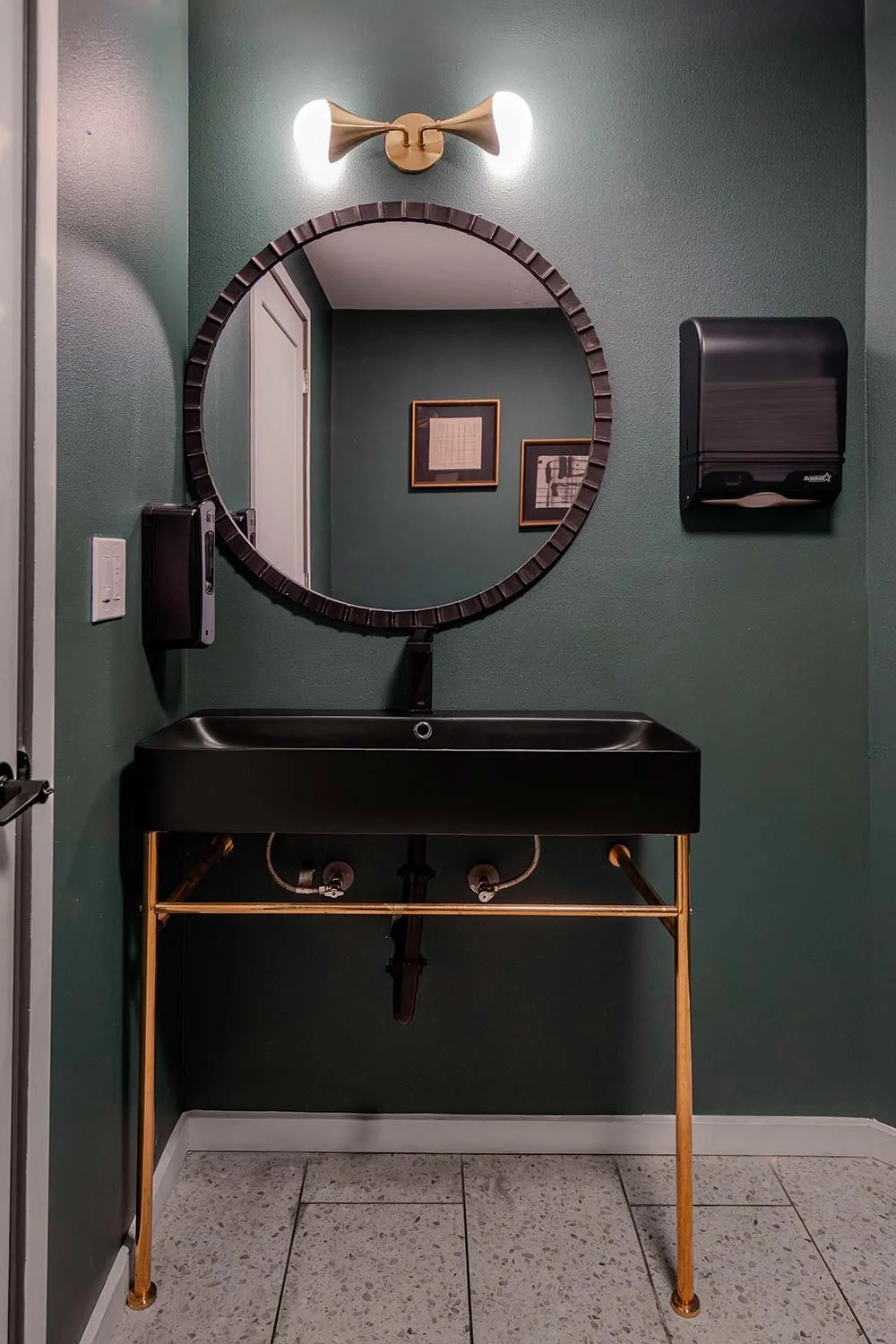Gold pedestal legs on  black sink