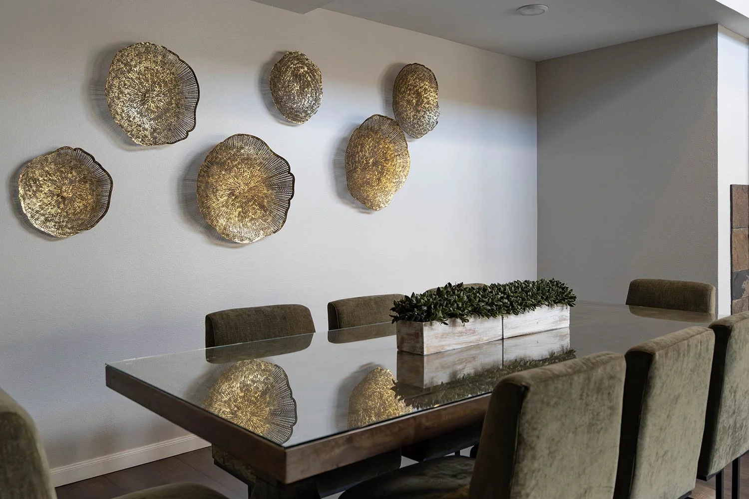 gold metal wall art over dining table