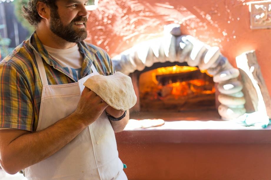  Chef Matt running the pizza oven at a private home in Sonoma. Photo by Alexander Reneff-Olson 