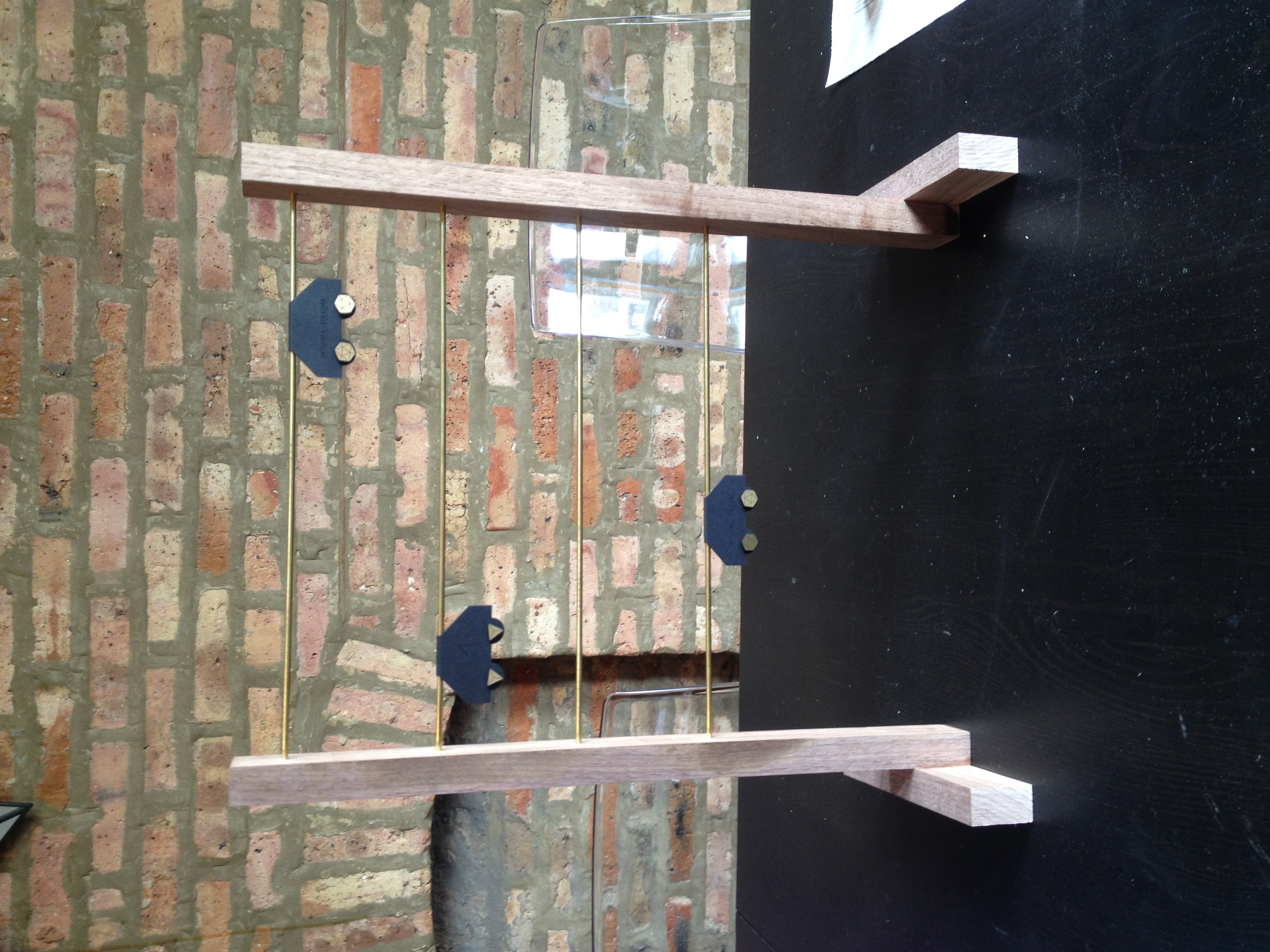 Hanging earring stand that we build out of walnut and brass