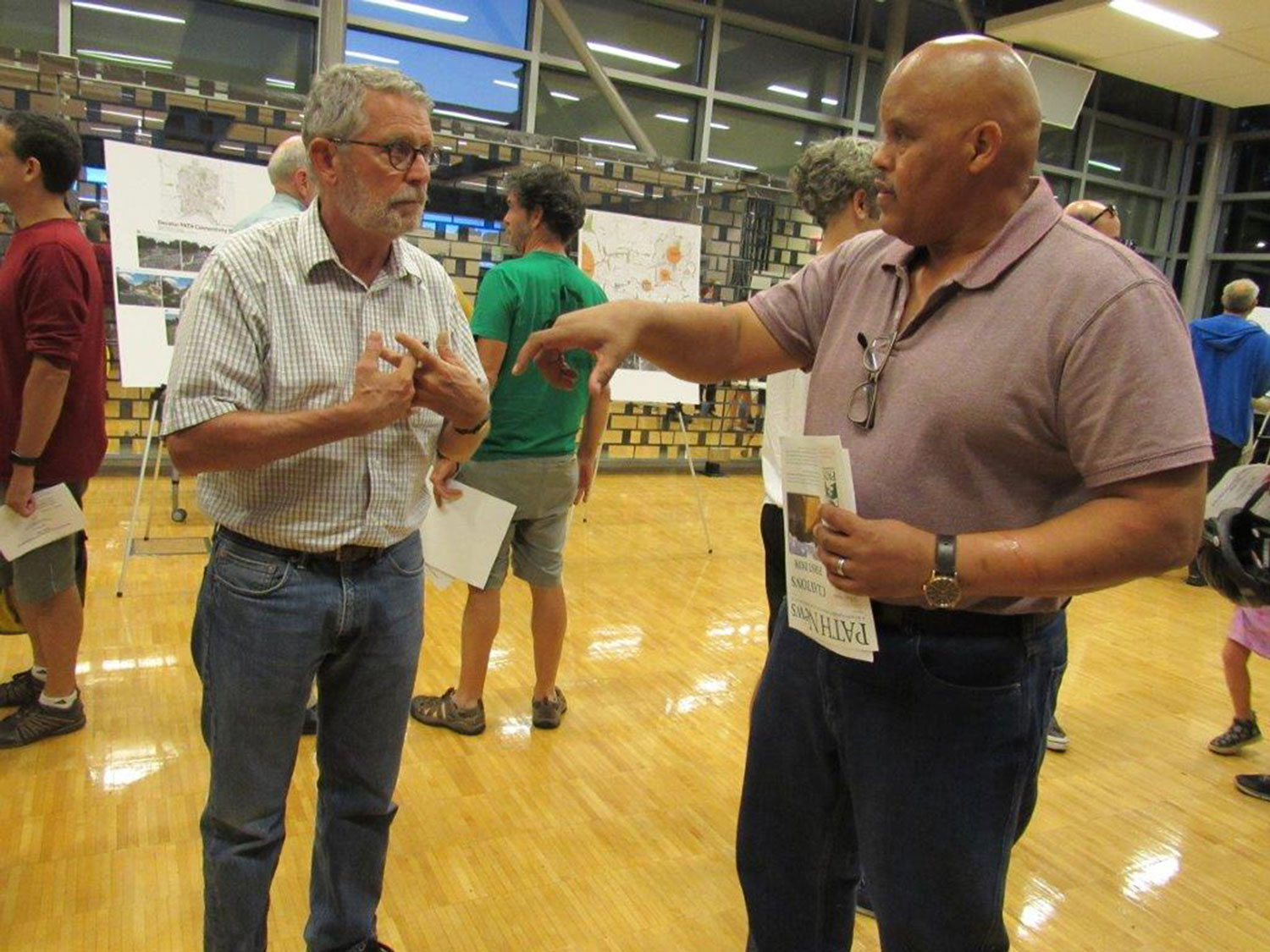  City Manager, Hugh Saxon, Deputy City Manager discusses the trail master plan with an interested citizen 