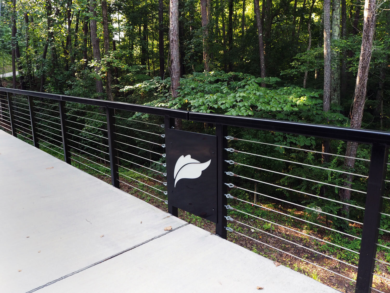  Proctor Creek Greenway logo shown on railing  