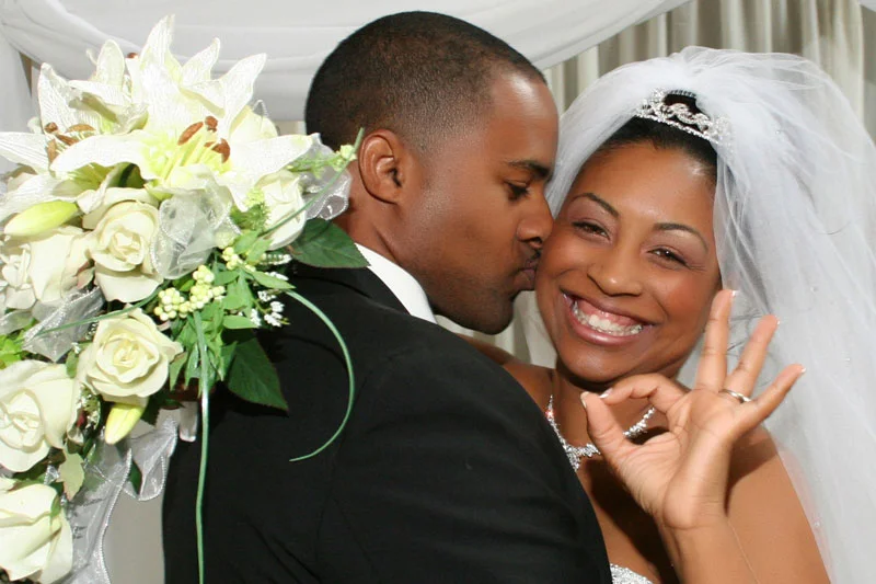 Groom kisses the bride - beautiful bouquet!