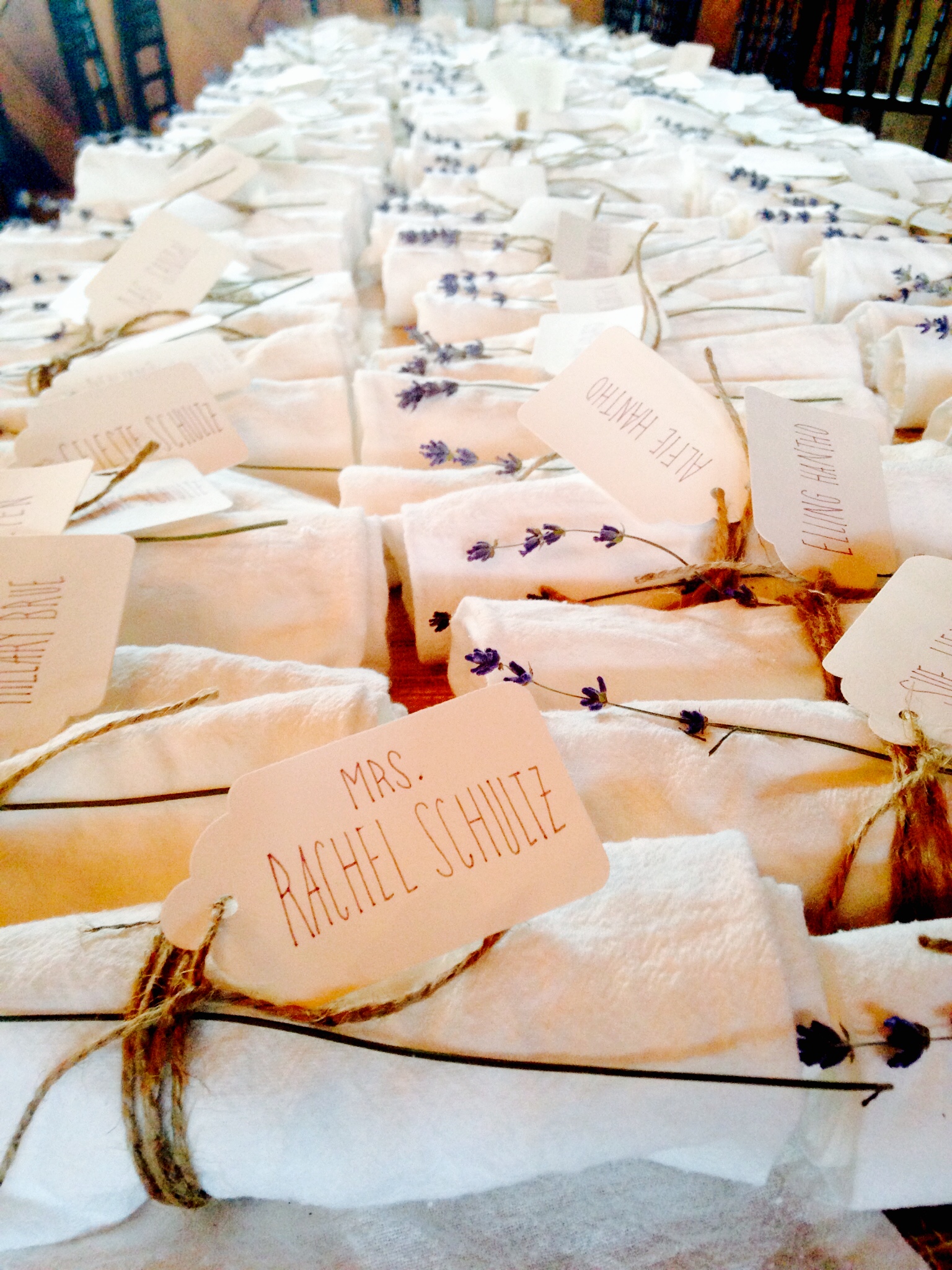 All bundled up and ready to go! These escort card/ french linen napkins were rolled with twine, sprigged with lavender cut from the property and placed on each plate.