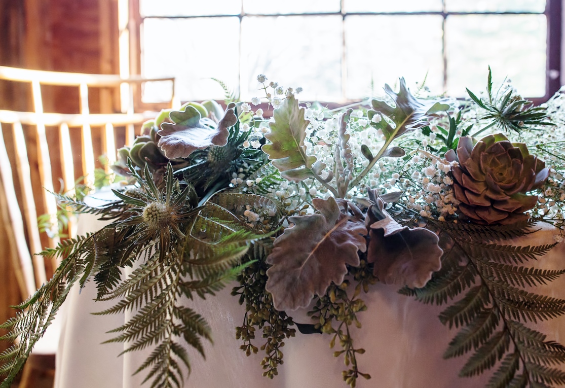 The monochromatic pallet of this sweetheart table decor is amazingly interesting because of all the gorgeous textures. I loved putting this together.
