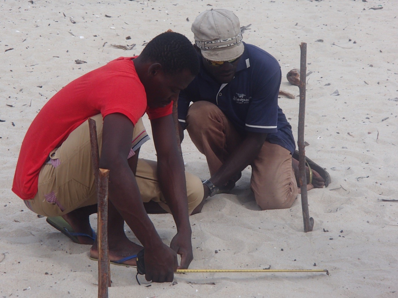 “Mestry” Abacar, and Abudu the Nema driver (master of all things car motor and here master of a tape measure) mark out the foundations.