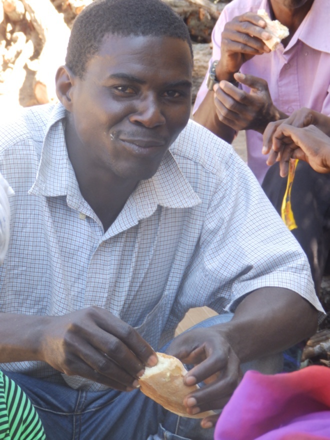 Carlos tastes the bread he taught the ladies how to make whilst he waits for the cakes to be mixed.