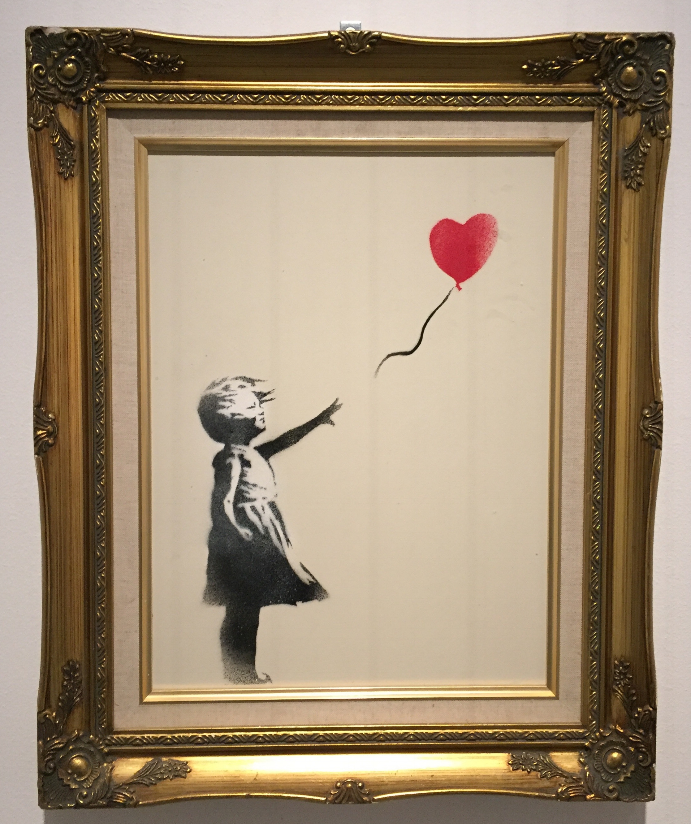 'Girl with Balloon', photo taken by Reem Gallery at the Banksy 'Guerra, Capitalismo & Liberta' exhibition in Rome 2016.