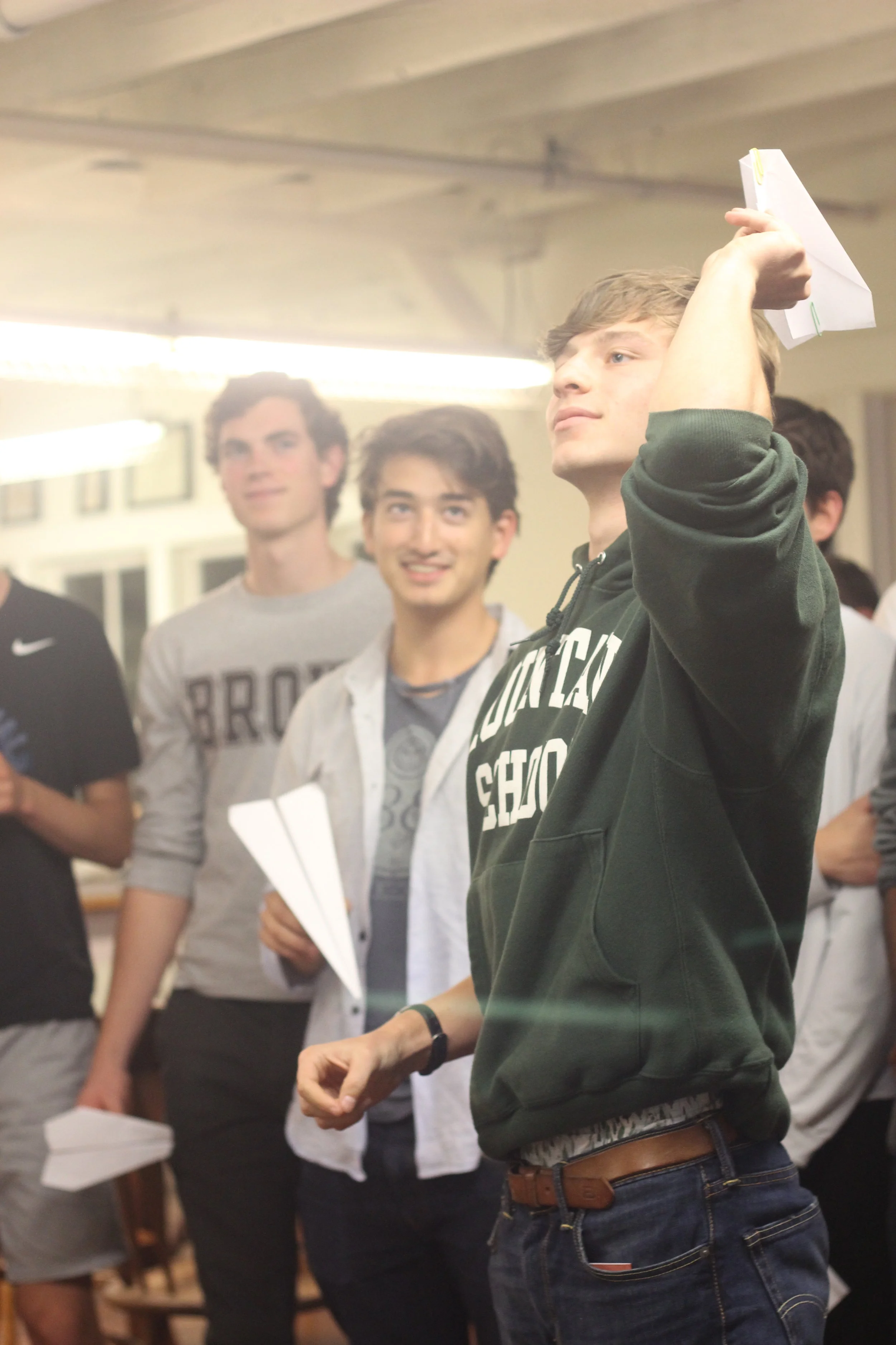 Having fun throwing paper airplanes.