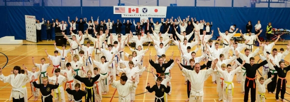 Competitors and officials raise their arms in the shape of a “Y” in support of Yoshukai founder Soke Katsuo Yamamoto Don Osborne Photography
