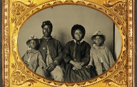 Quarter-Plate Ambrotype taken between 1863 and 1865. Image depicts a Black Union Army private and his wife and twin daughters.